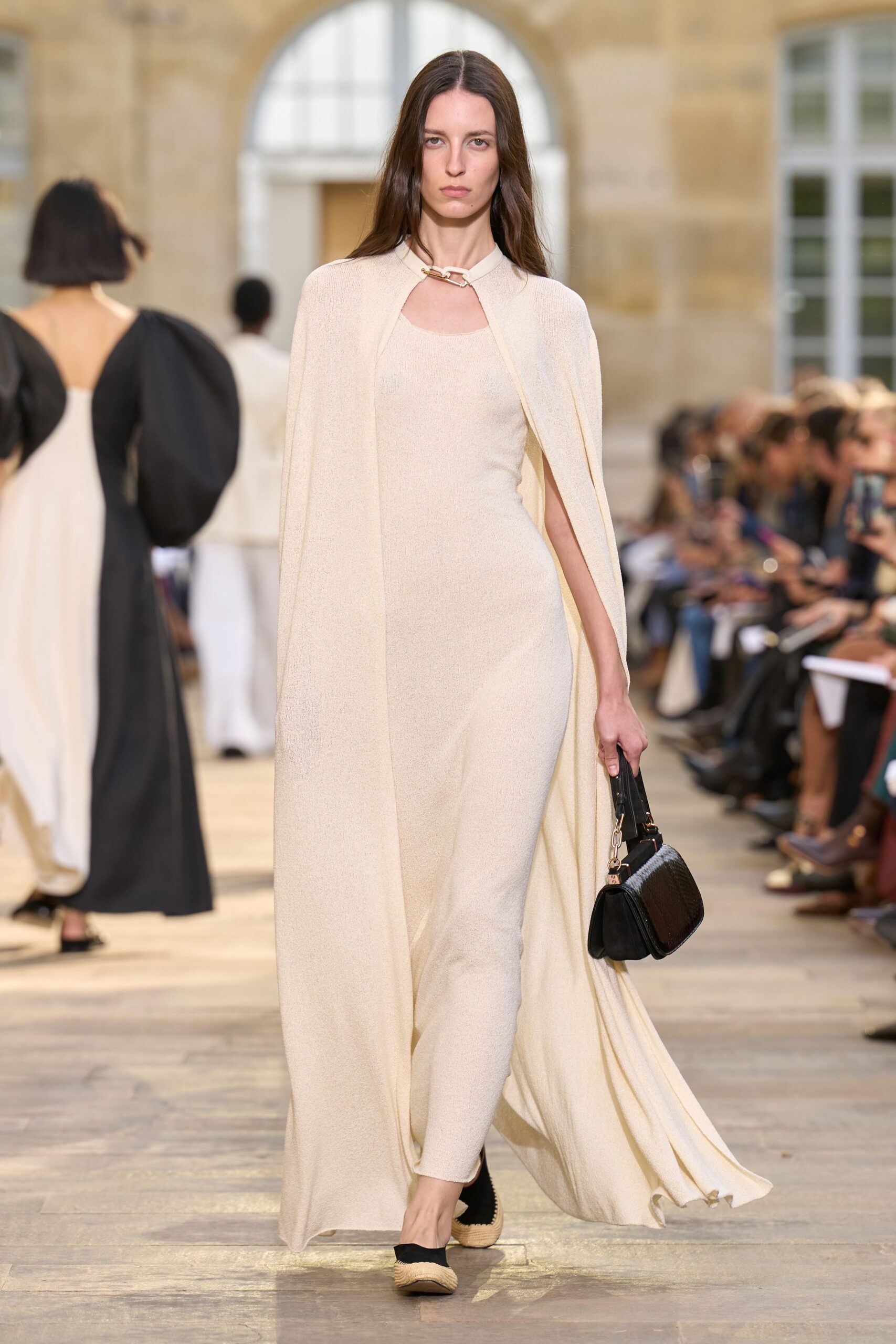 beige silk sleeveless high-neck fitted draped flowing gown