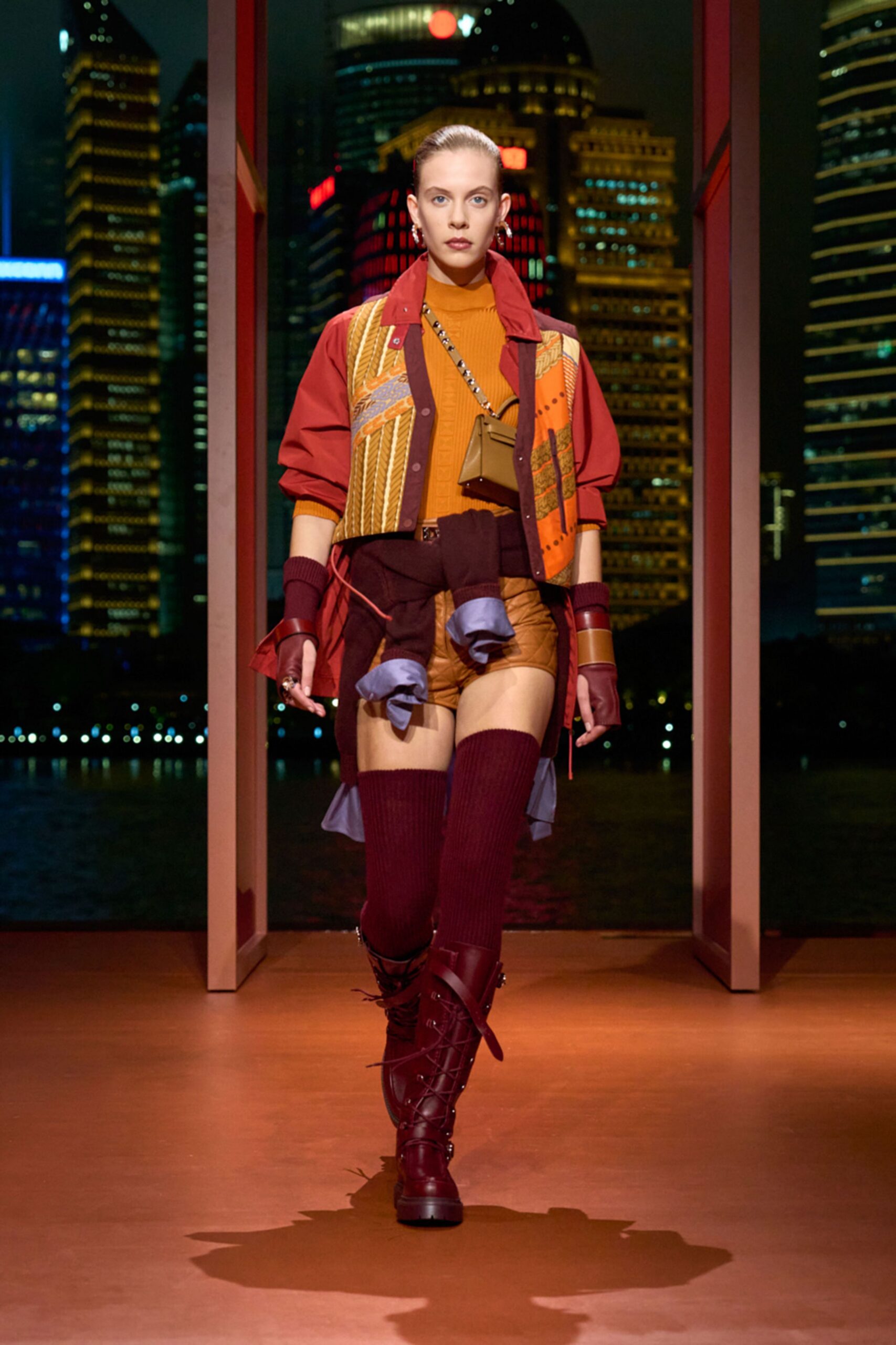 red jacket orange top brown shorts