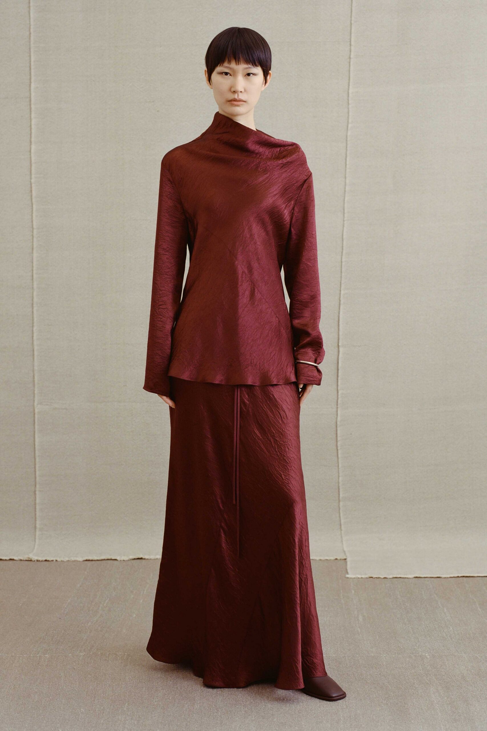 maroon silk long-sleeve high-neck fitted draped top
