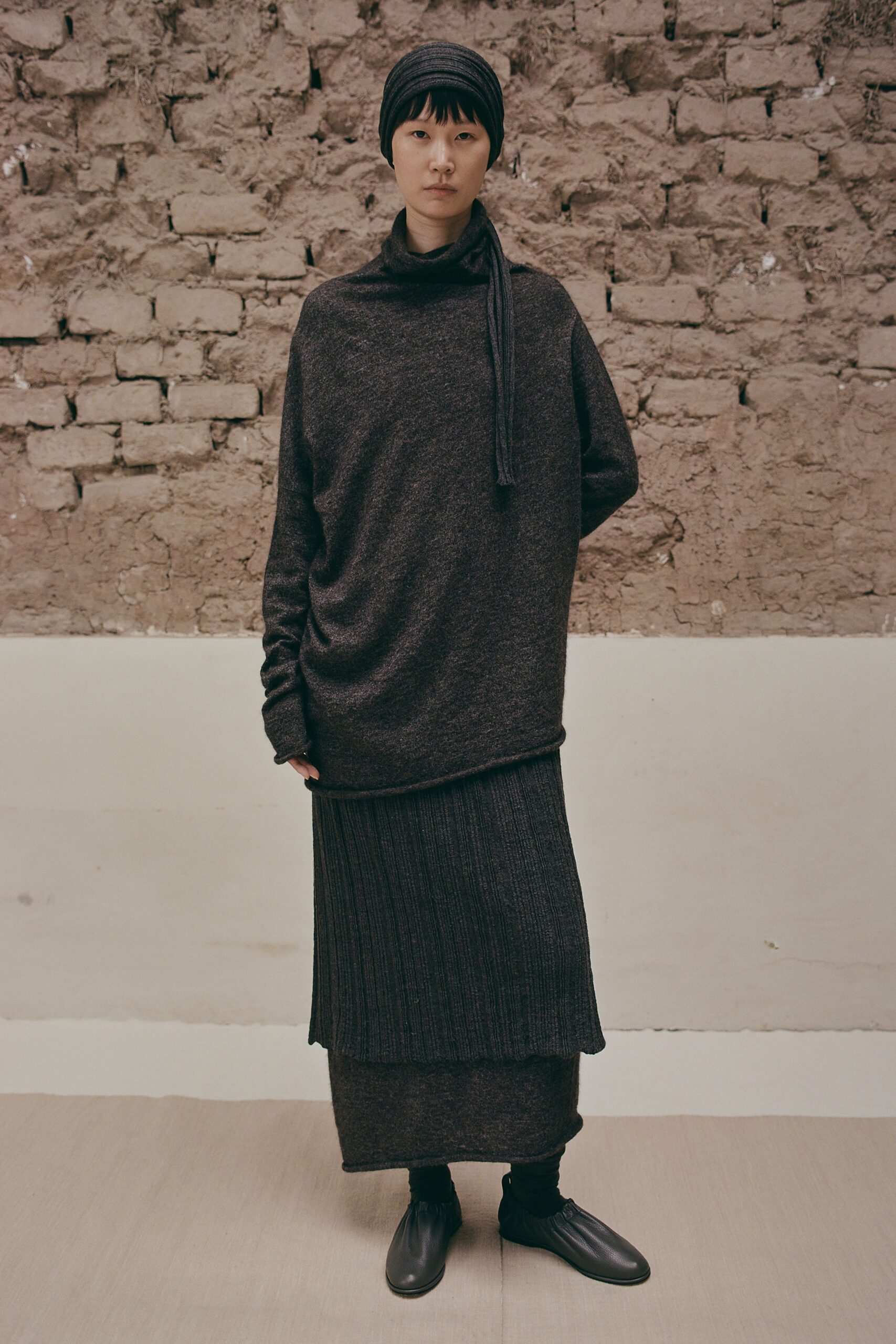 black wool long-sleeve high-neck relaxed draped top