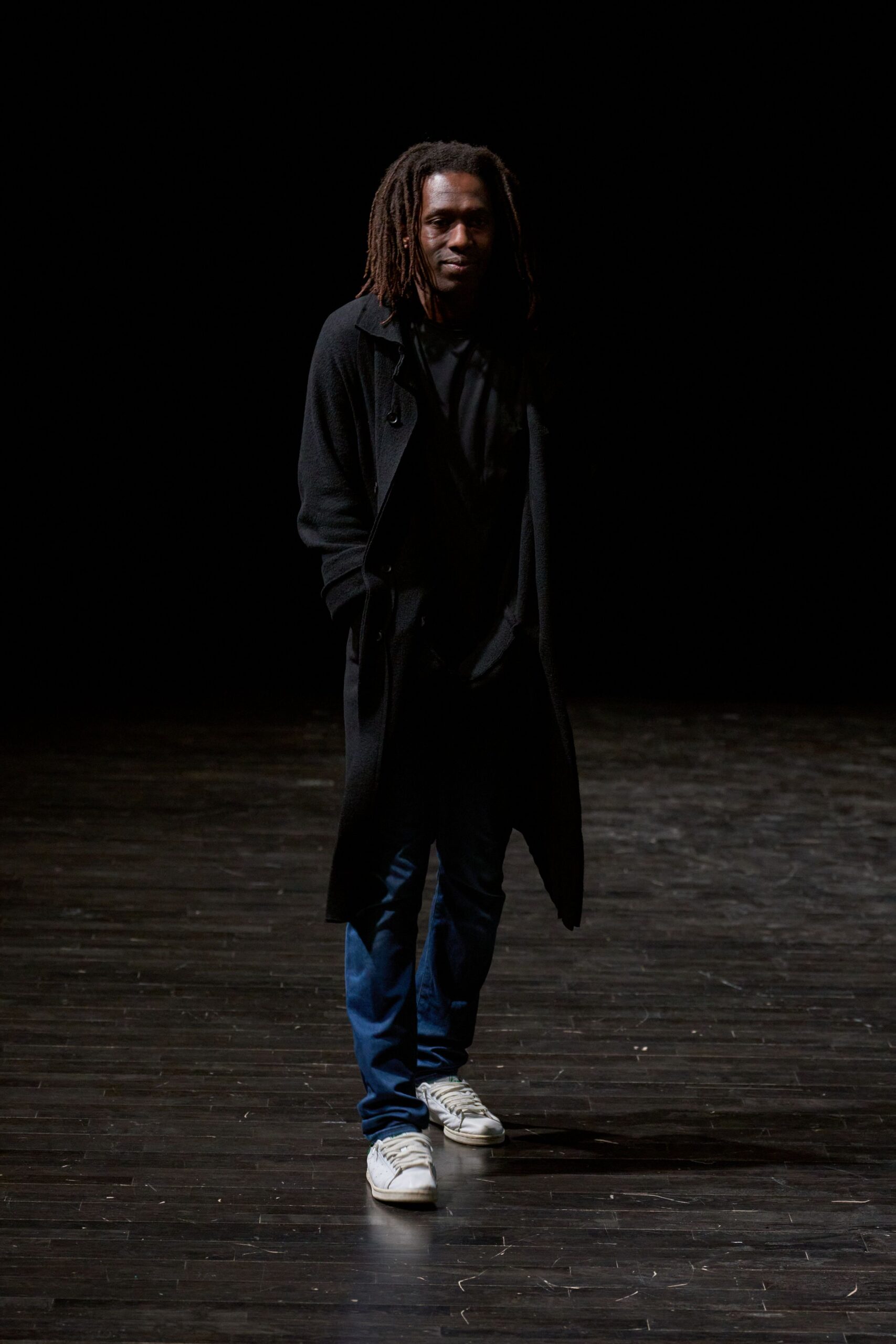 black coat with black shirt and blue pants