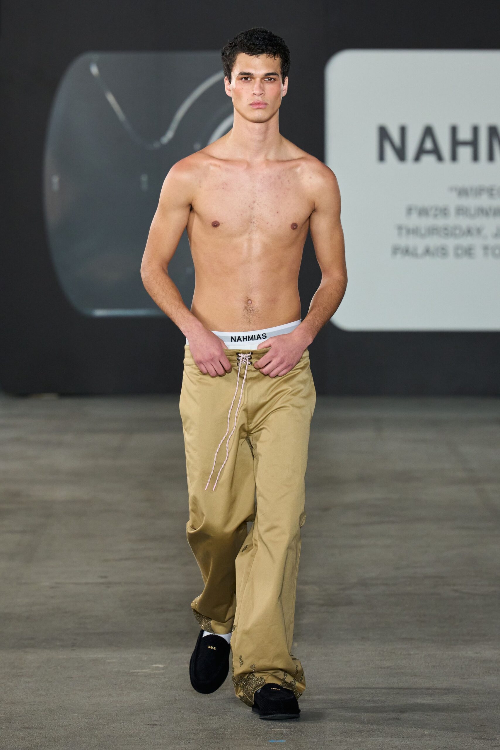 beige relaxed pants with black shoes