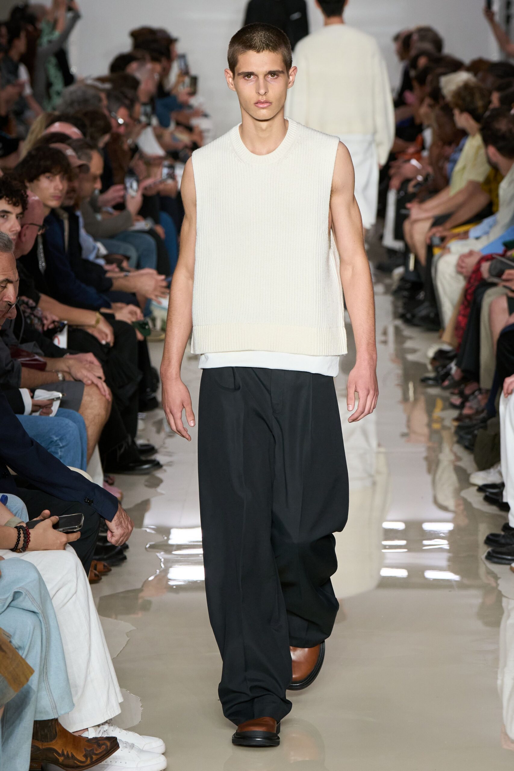 white sleeveless sweater with black pants
