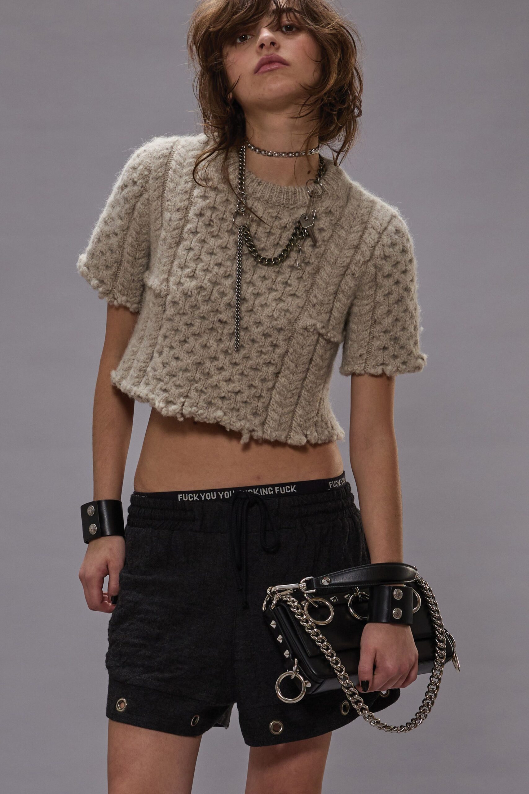 beige cropped top with black shorts