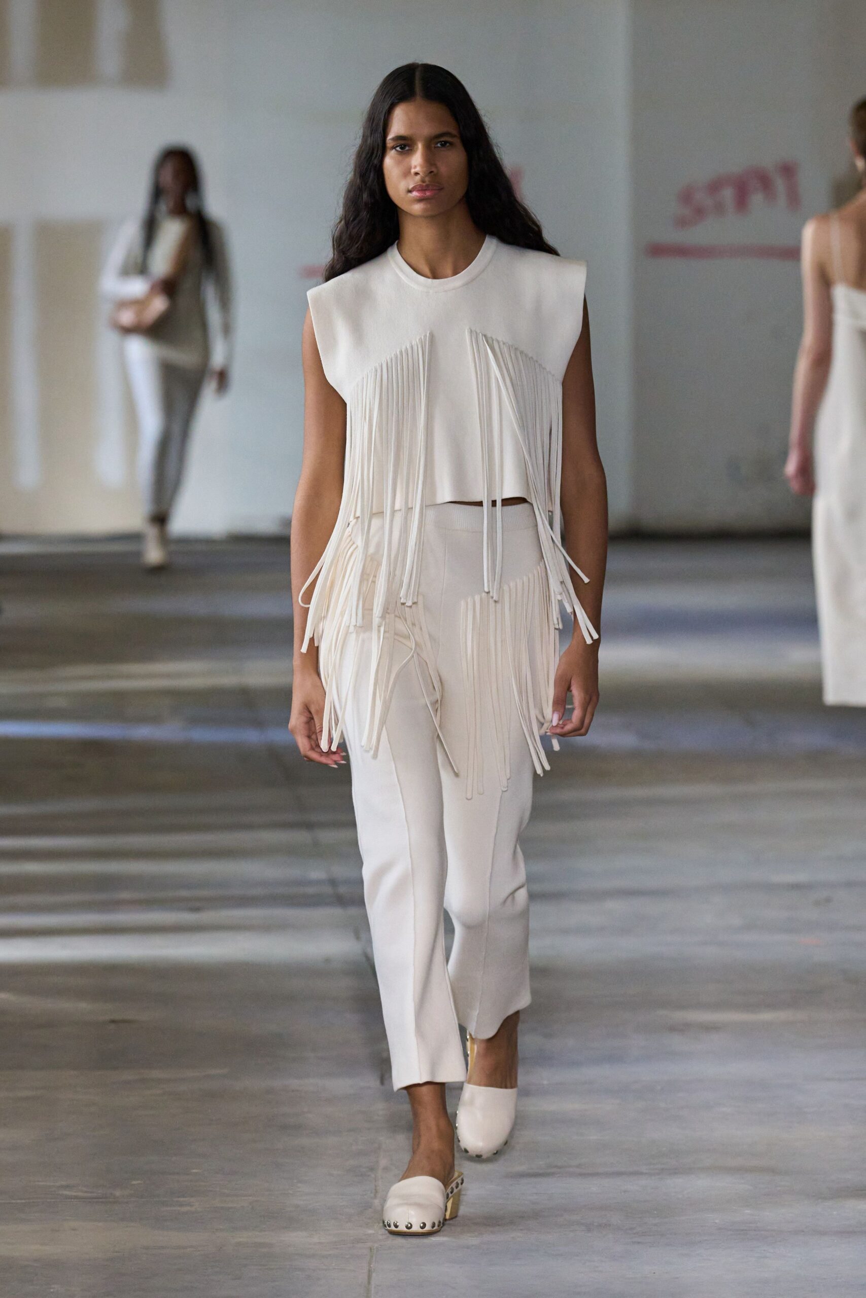 white fringed top and fitted pants