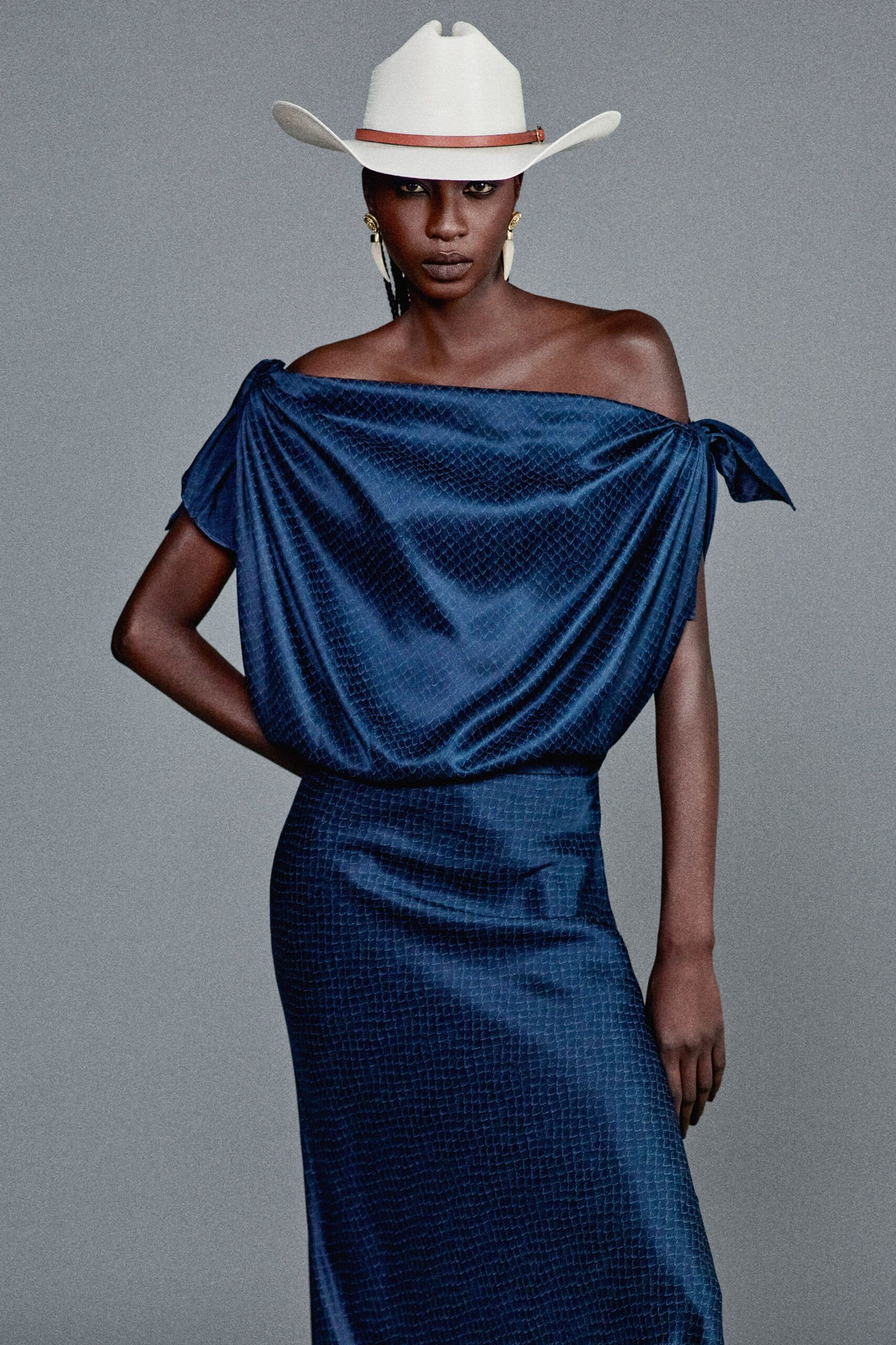 blue silk off-shoulder dress with white hat