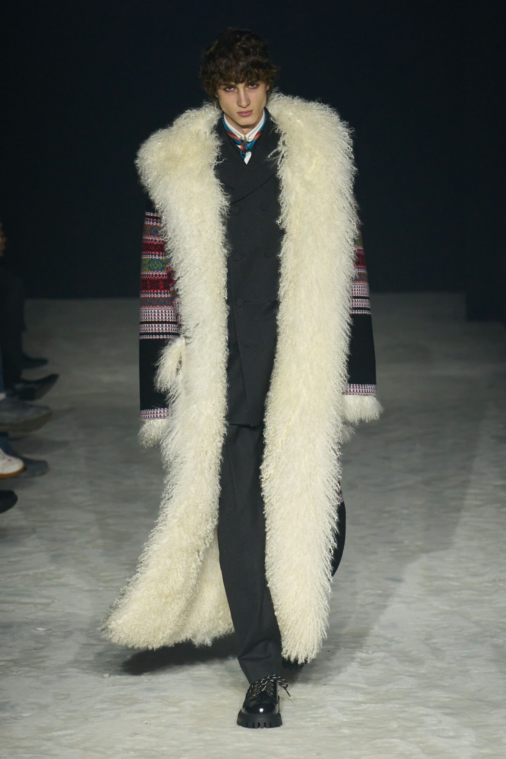 white faux-fur coat with black suit