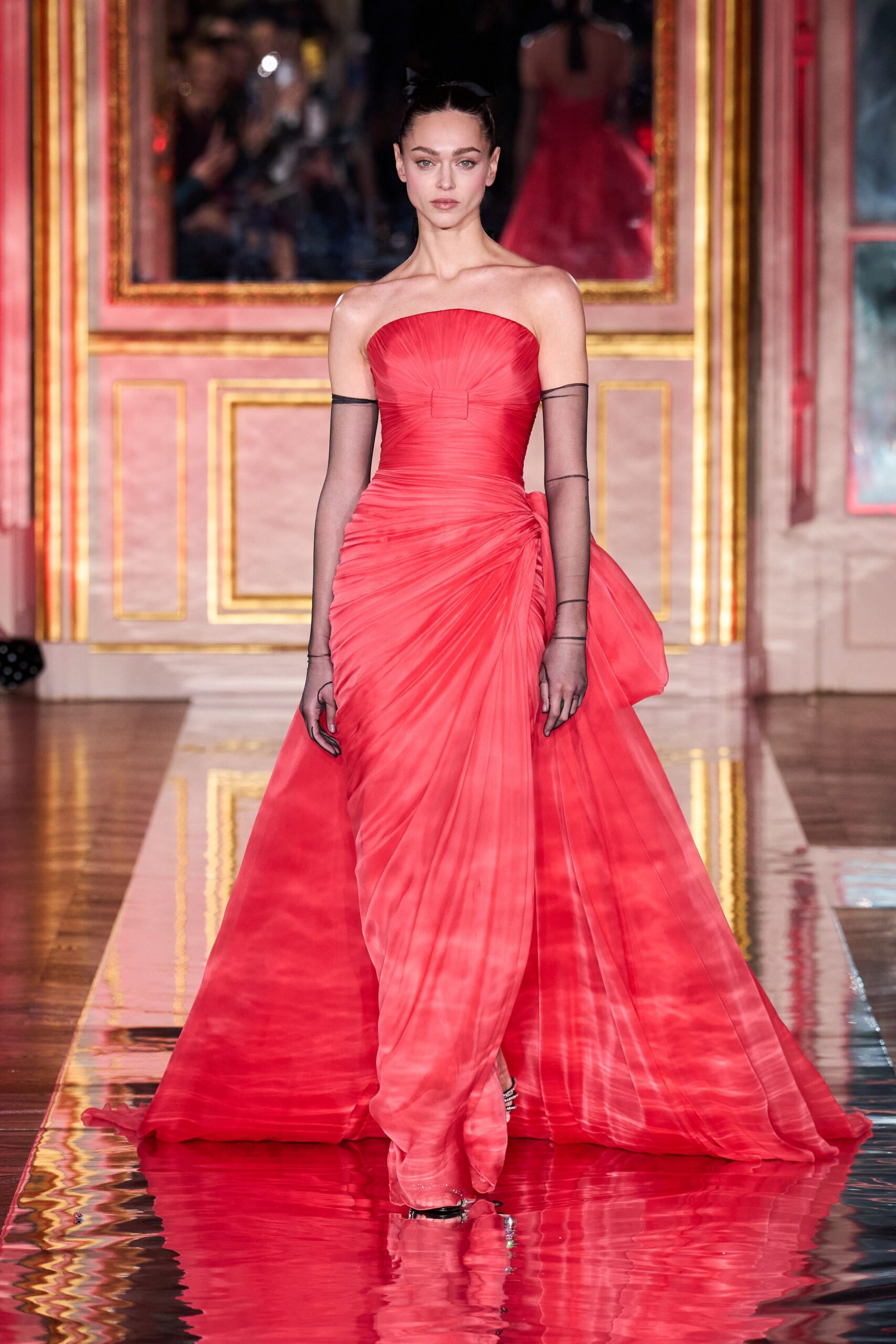 red silk strapless fitted pleated draped flowing gown
