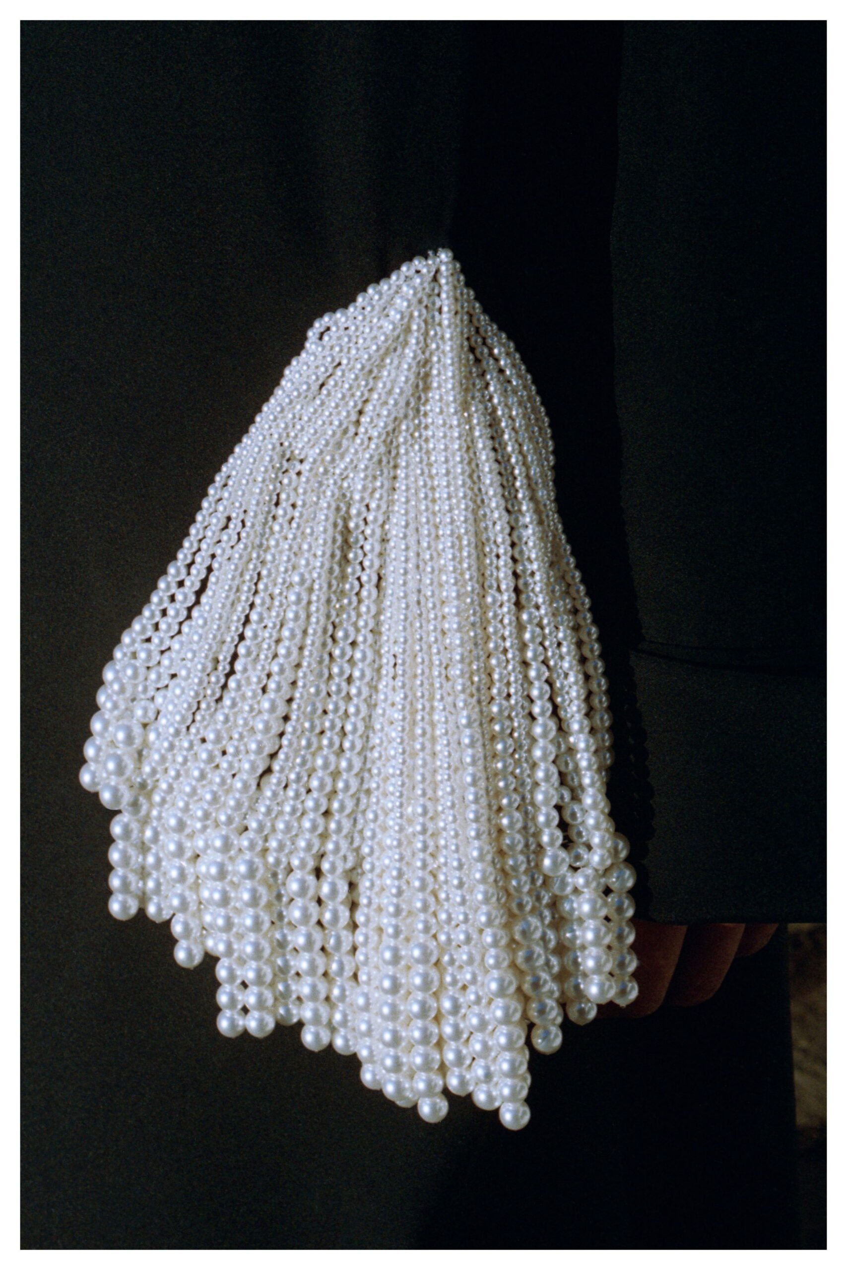 black wool coat with beaded bag