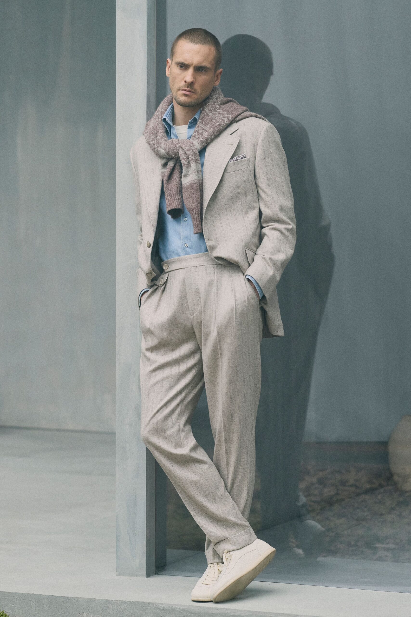 beige tailored suit with blue shirt