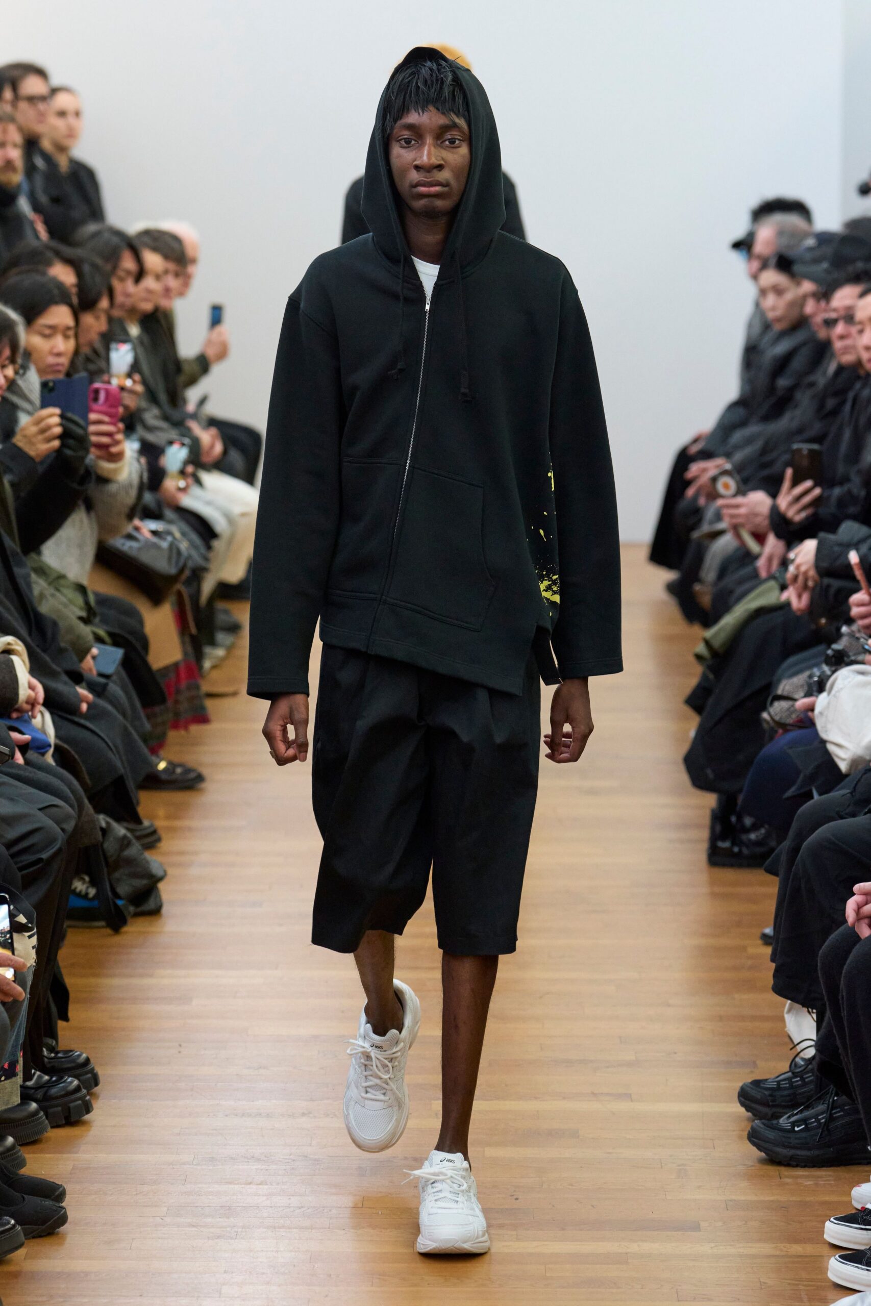 black hoodie and shorts with white sneakers