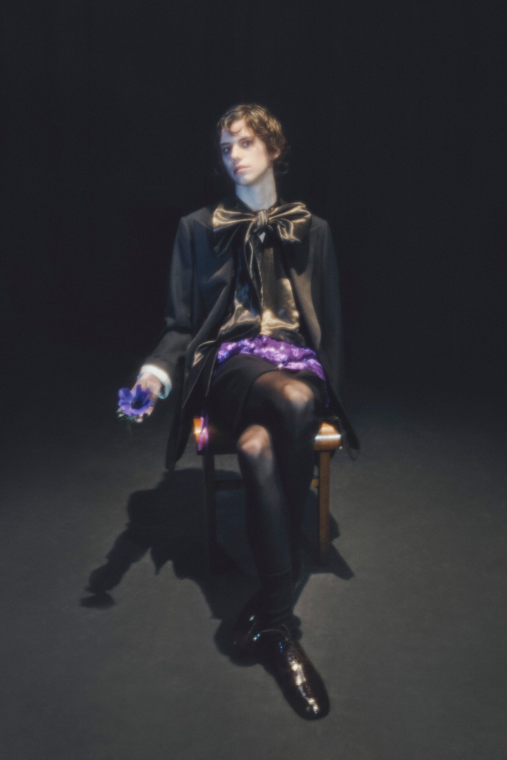 black silk blazer and top with purple skirt
