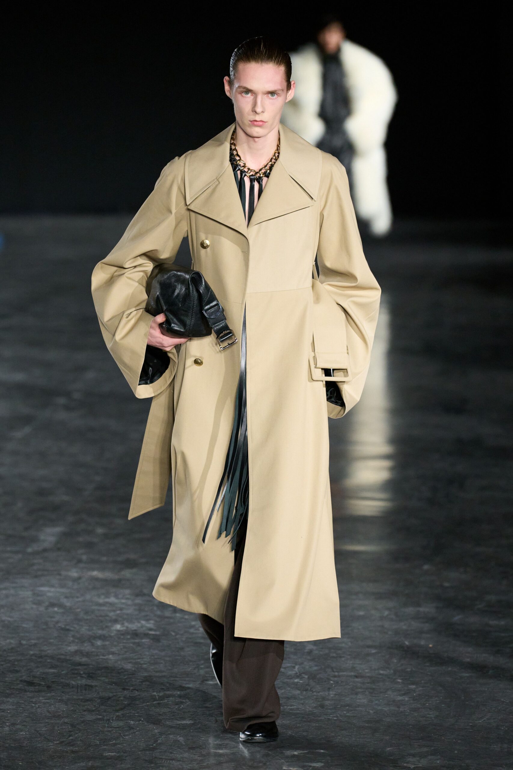beige trench coat with black bag