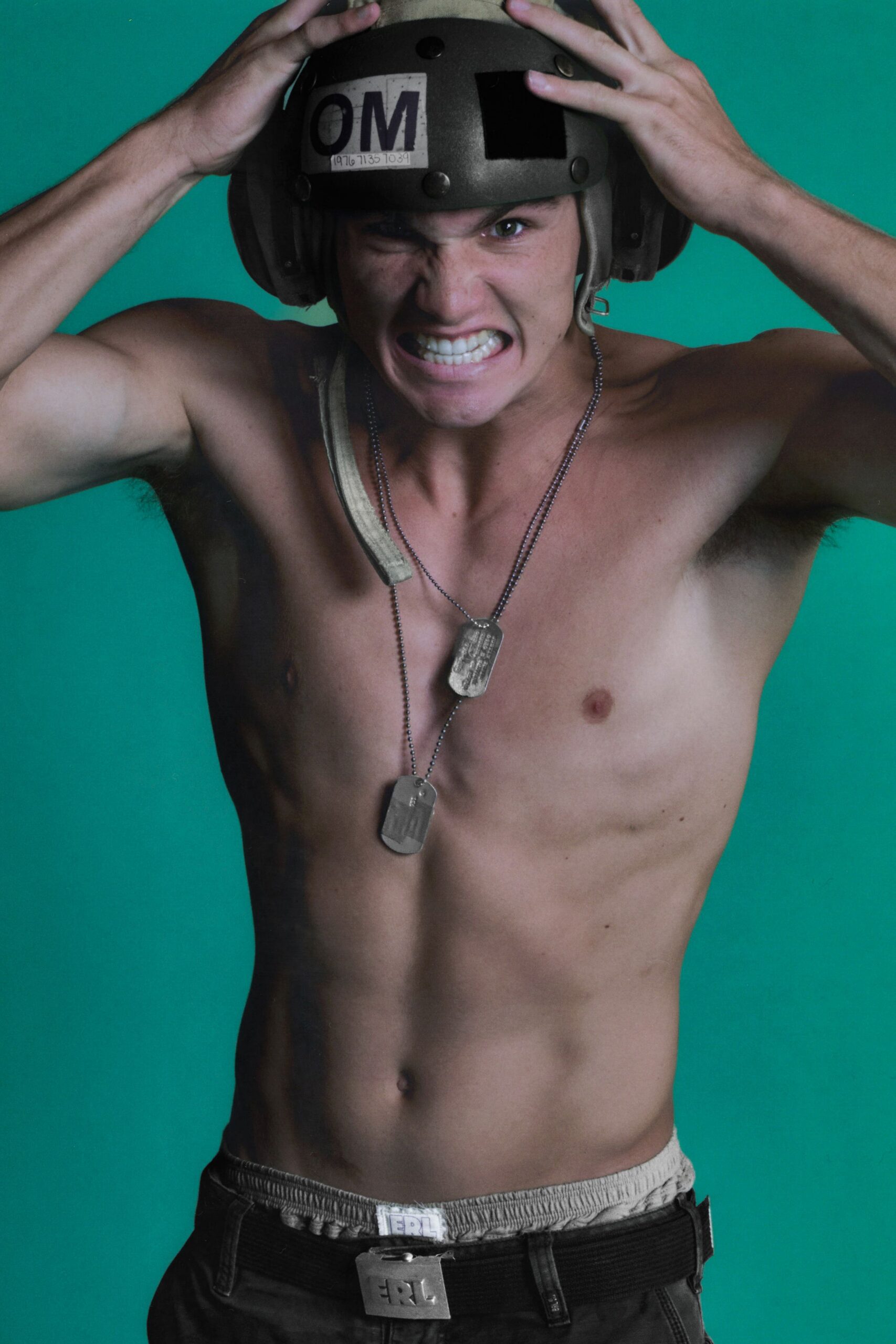 beige fitted pants with green hat