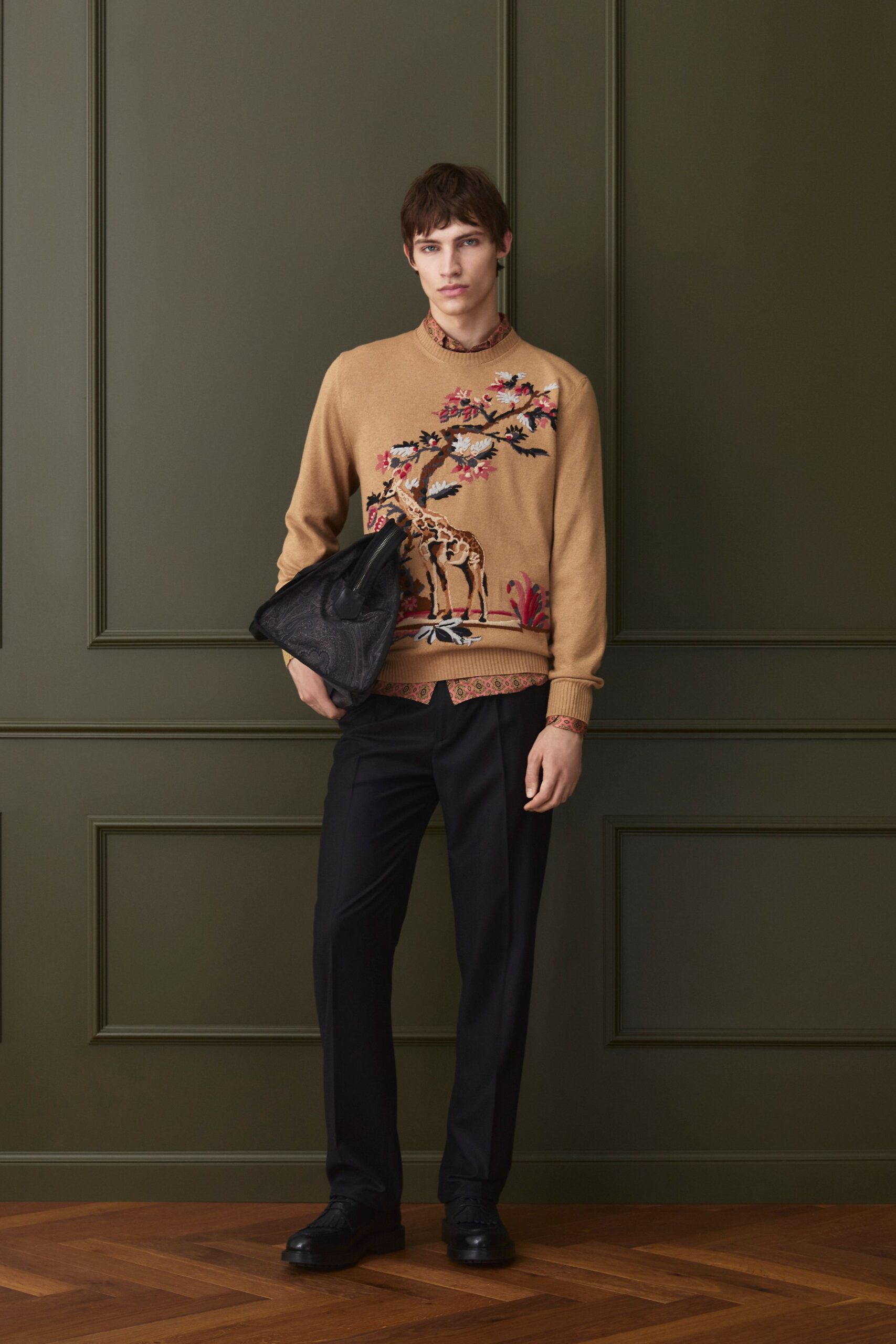 beige embroidered sweater with black pants