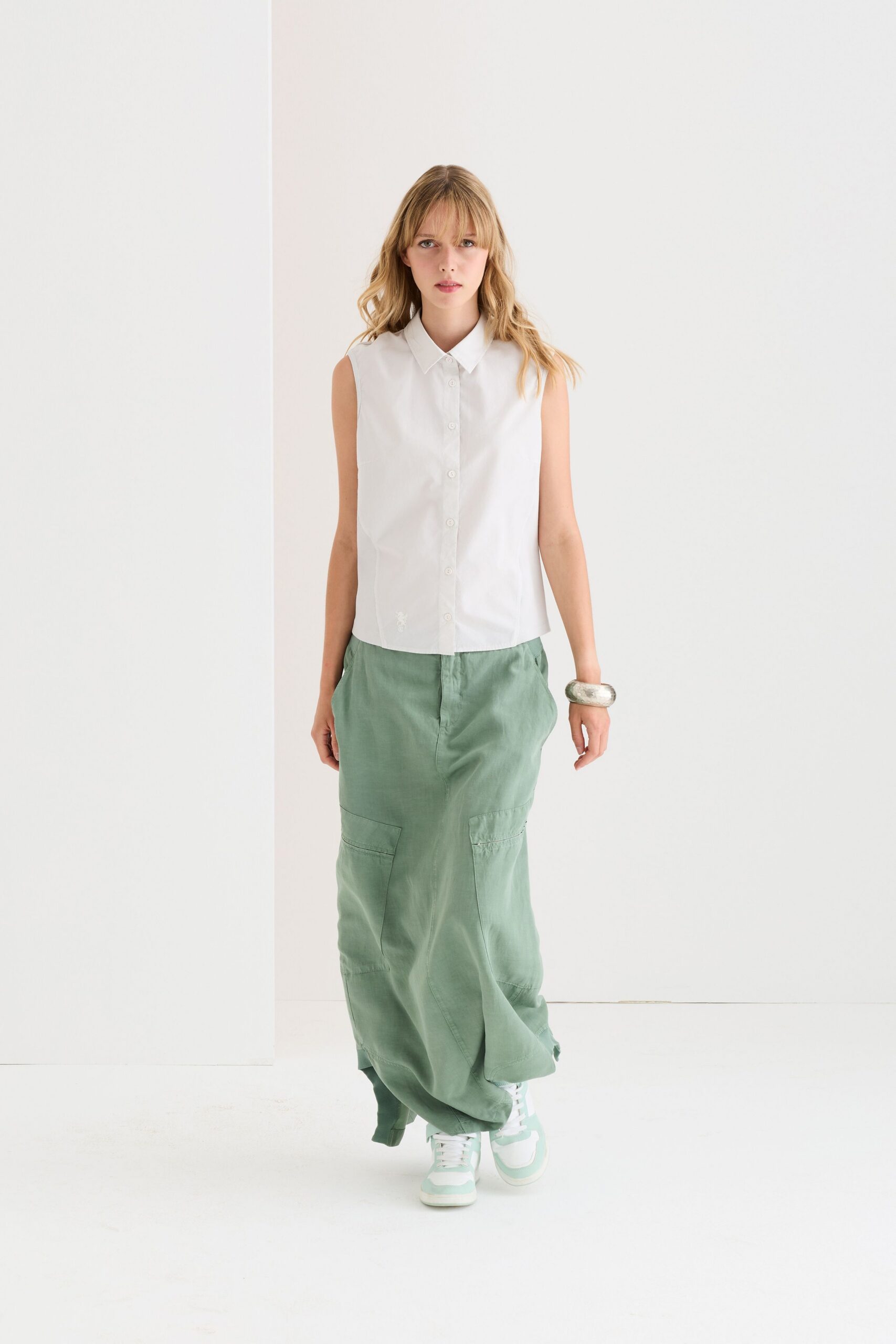 white sleeveless shirt and green maxi skirt