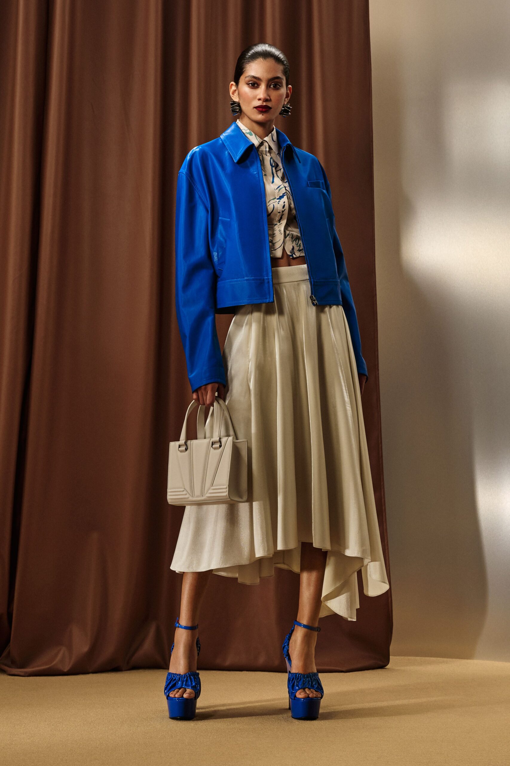 blue leather jacket with beige skirt