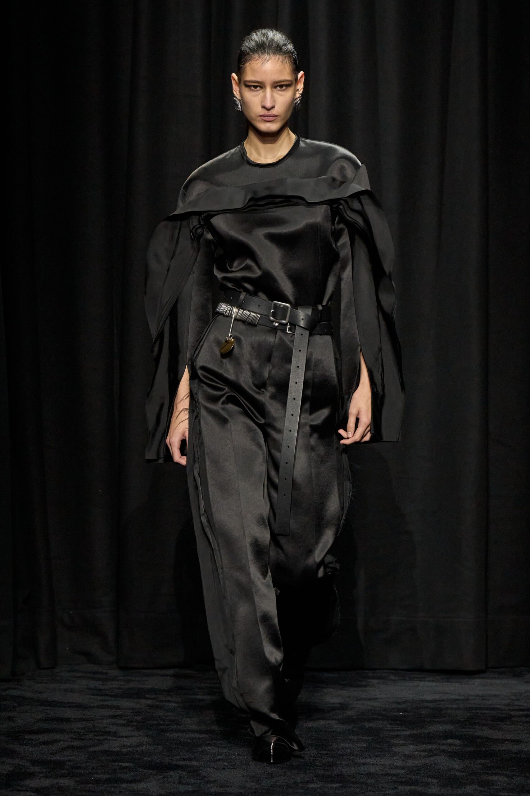 black silk off-shoulder top and fitted pants