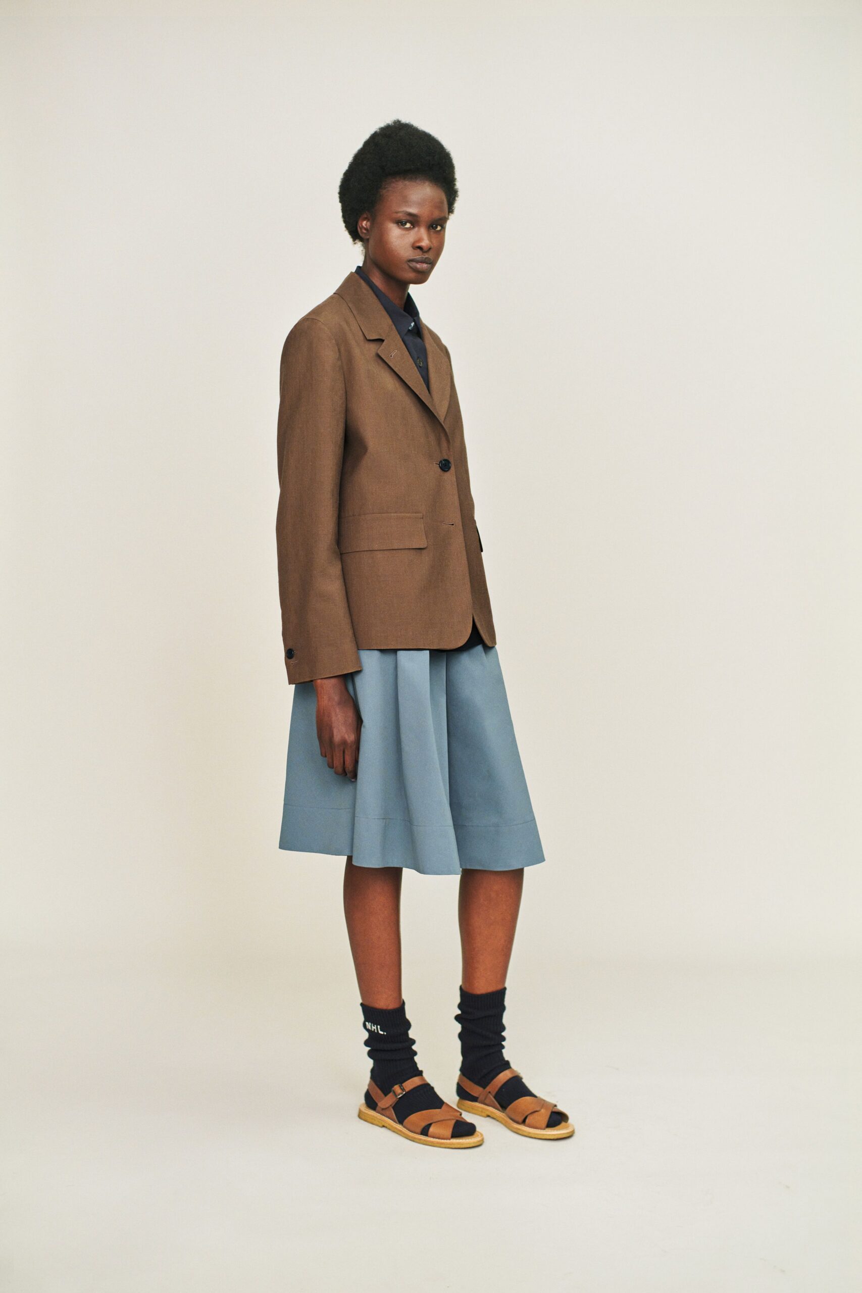brown tailored blazer with blue skirt