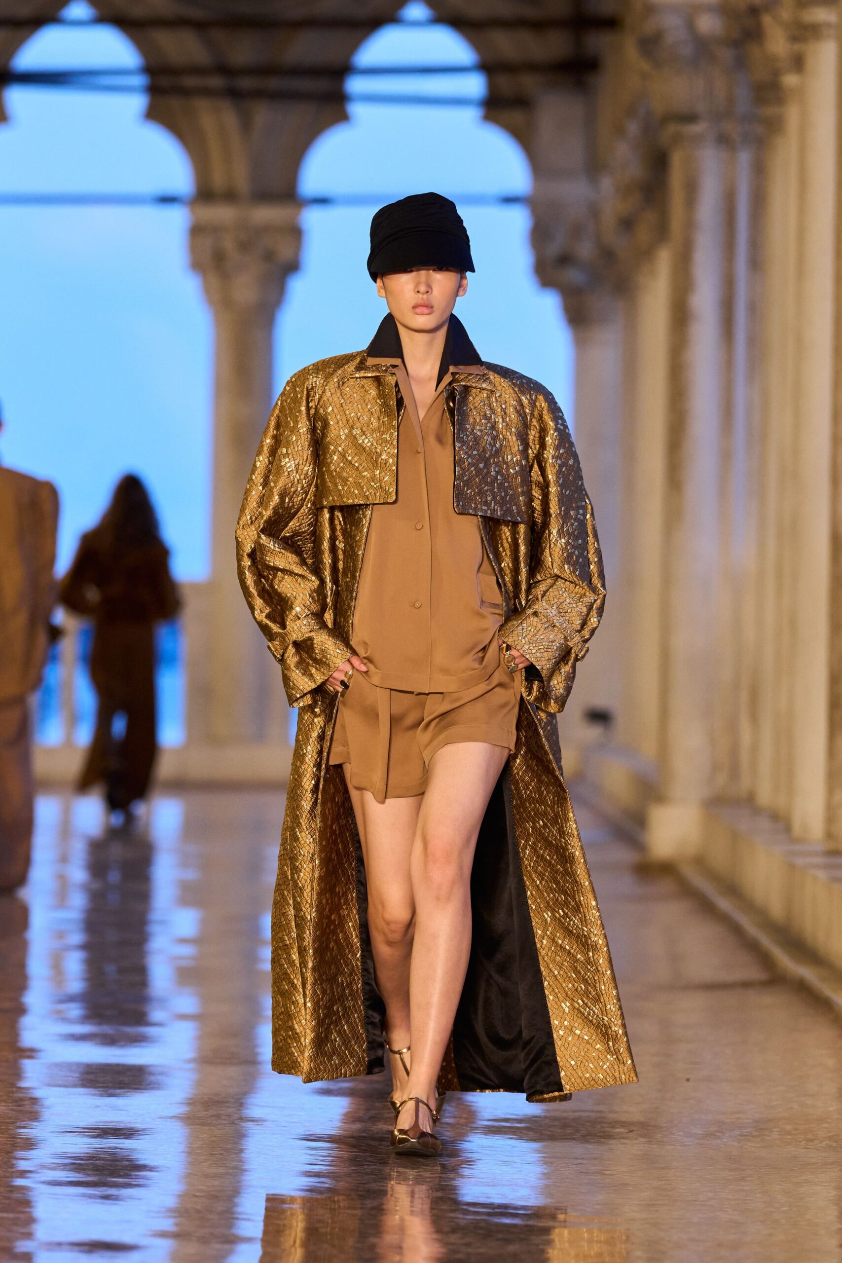 gold oversized coat with brown jumpsuit