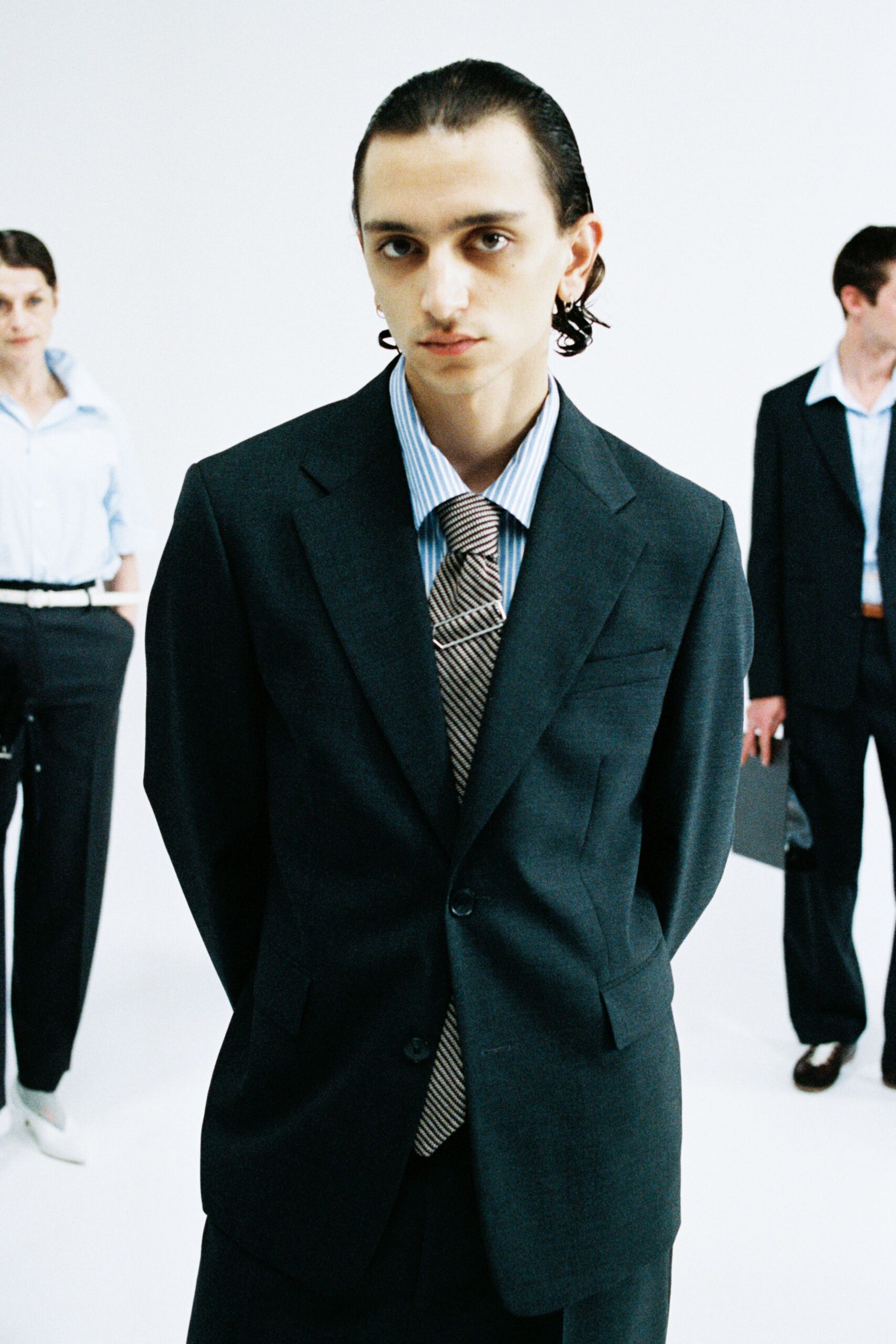 black tailored suit with blue shirt