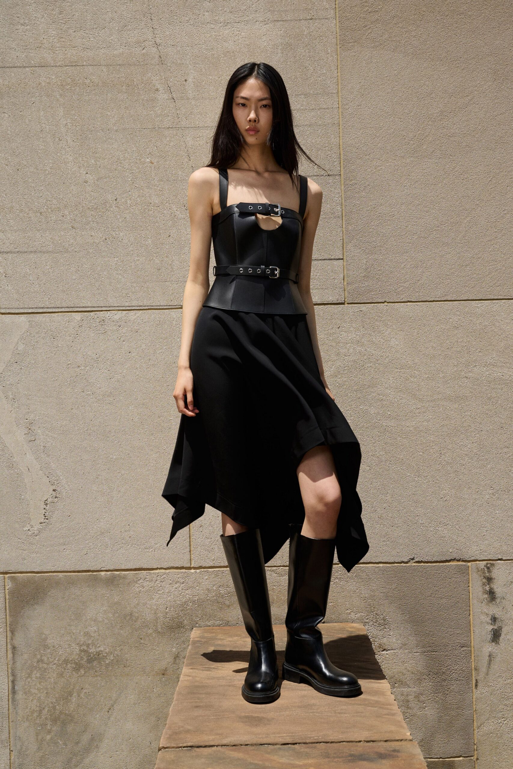 black leather sleeveless asymmetric dress with boots