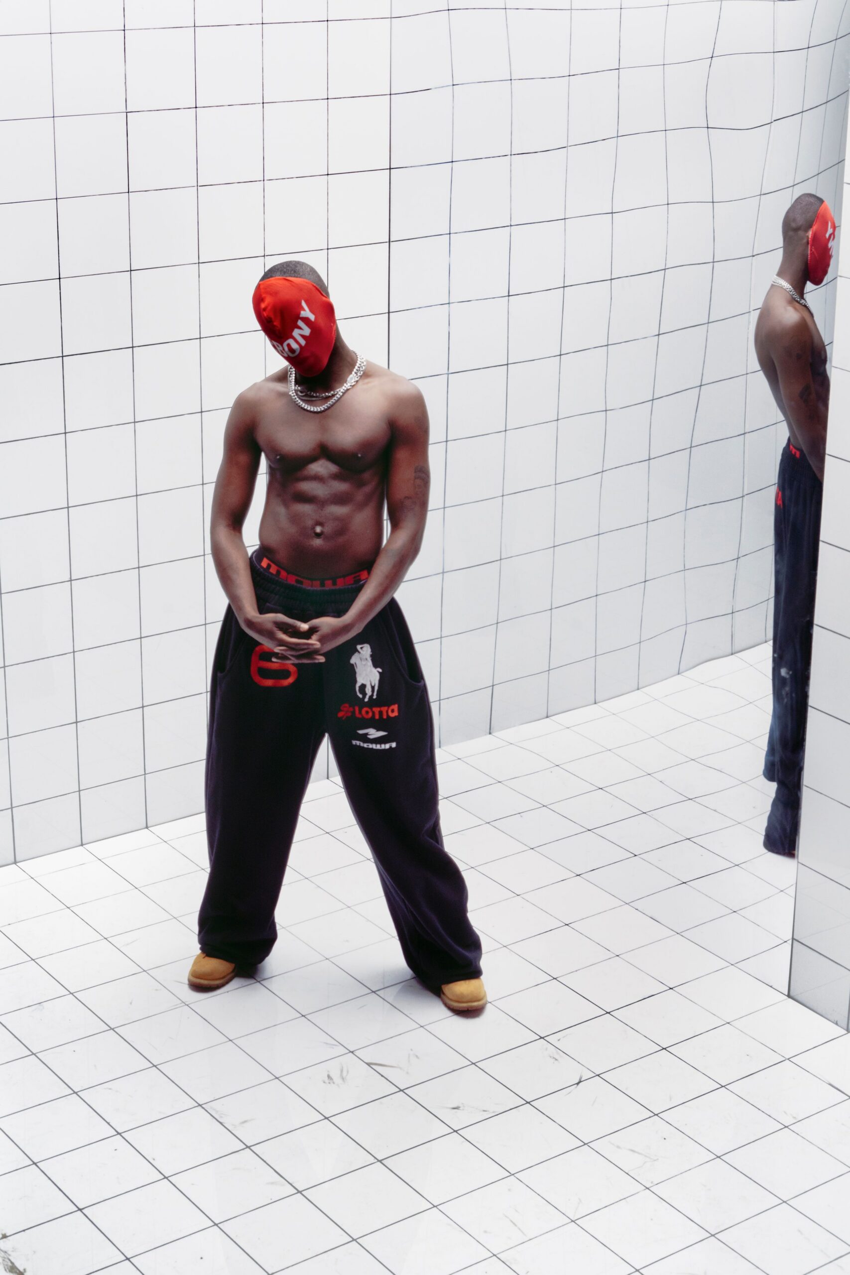 black relaxed pants with red hat