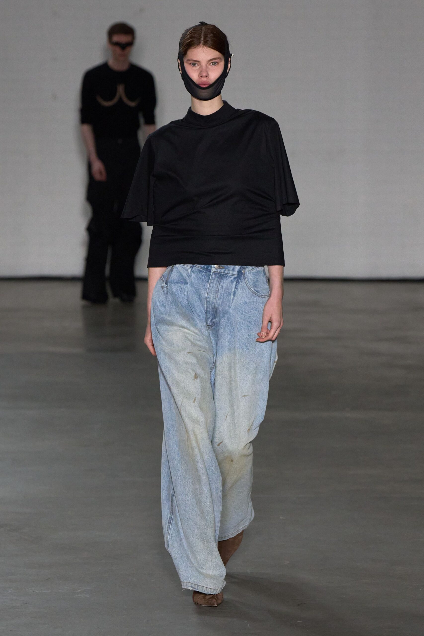 black relaxed top with blue denim pants