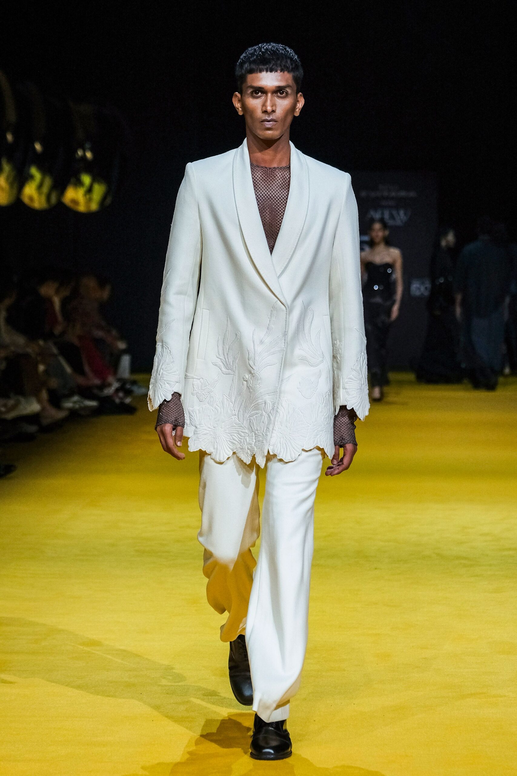 white tailored suit with black shoes
