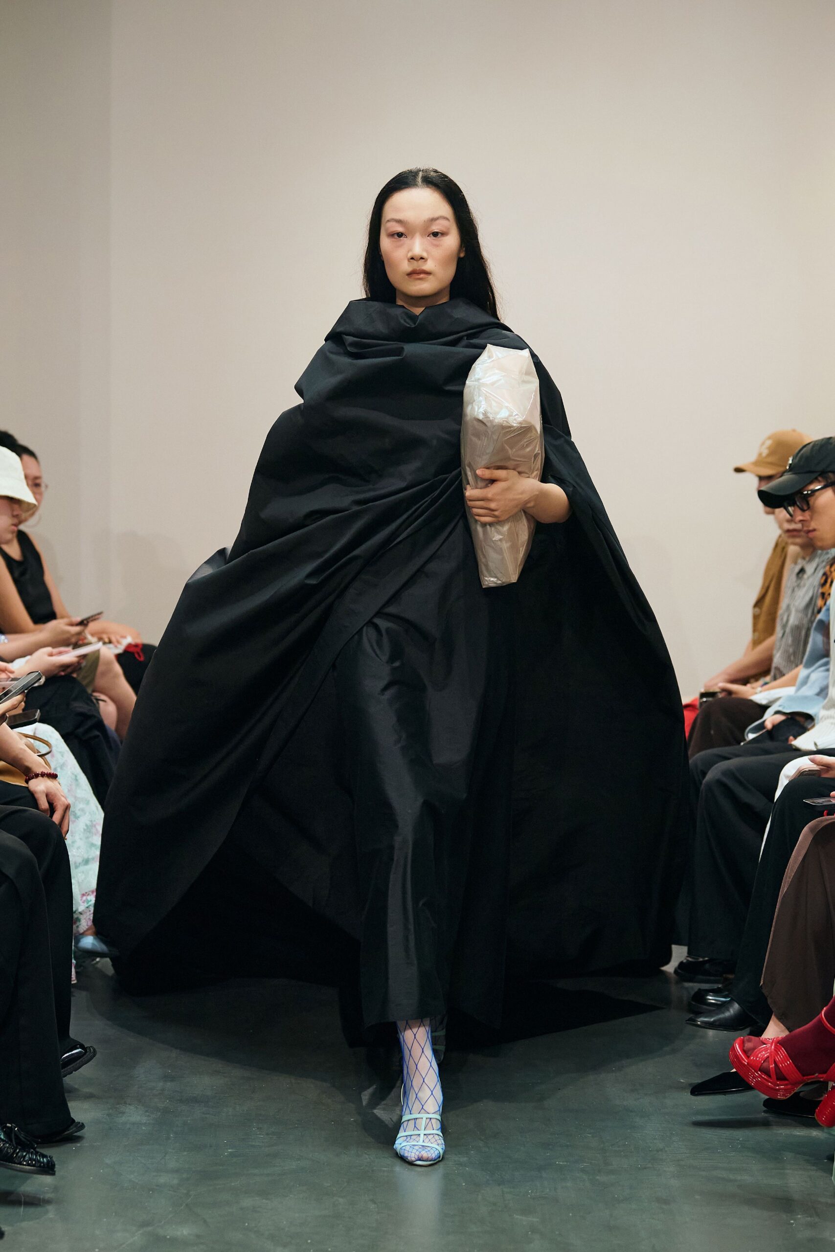 black cape and dress with blue shoes
