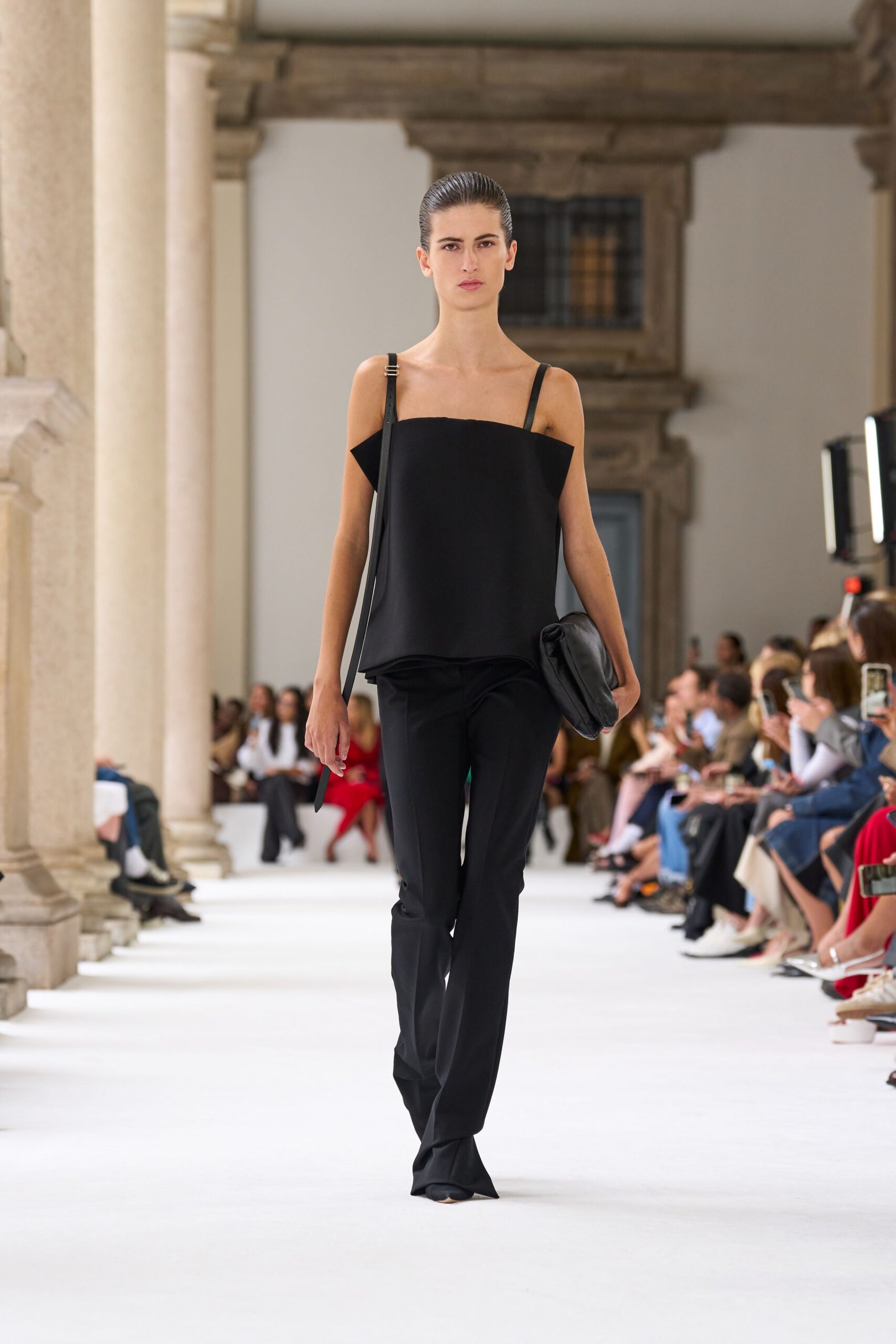 black silk sleeveless top and fitted pants