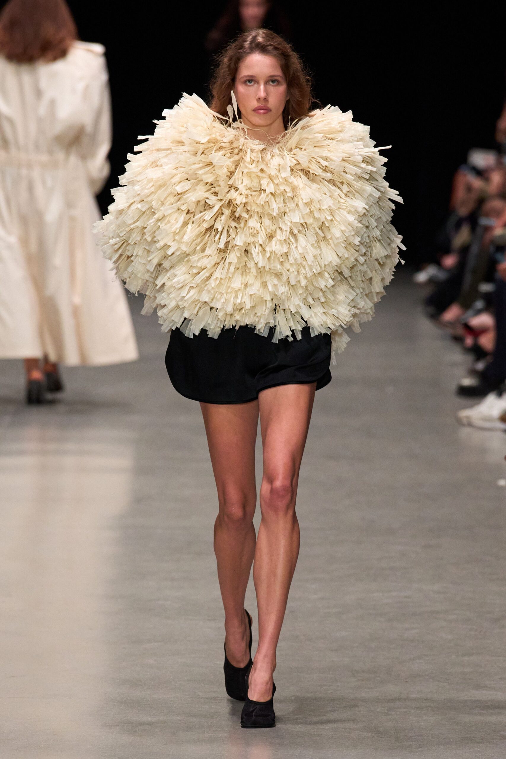 ivory ruffled top with black shorts