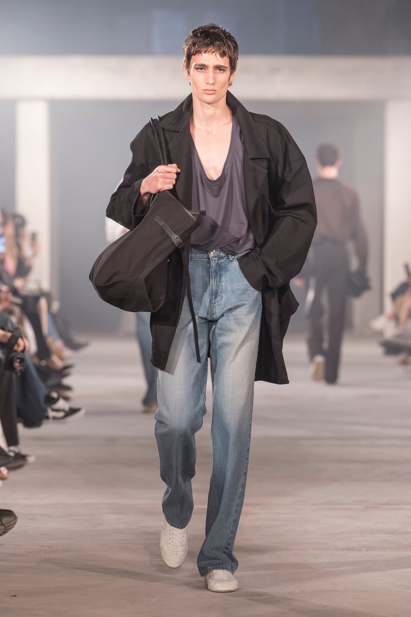 black coat gray top blue jeans white shoes