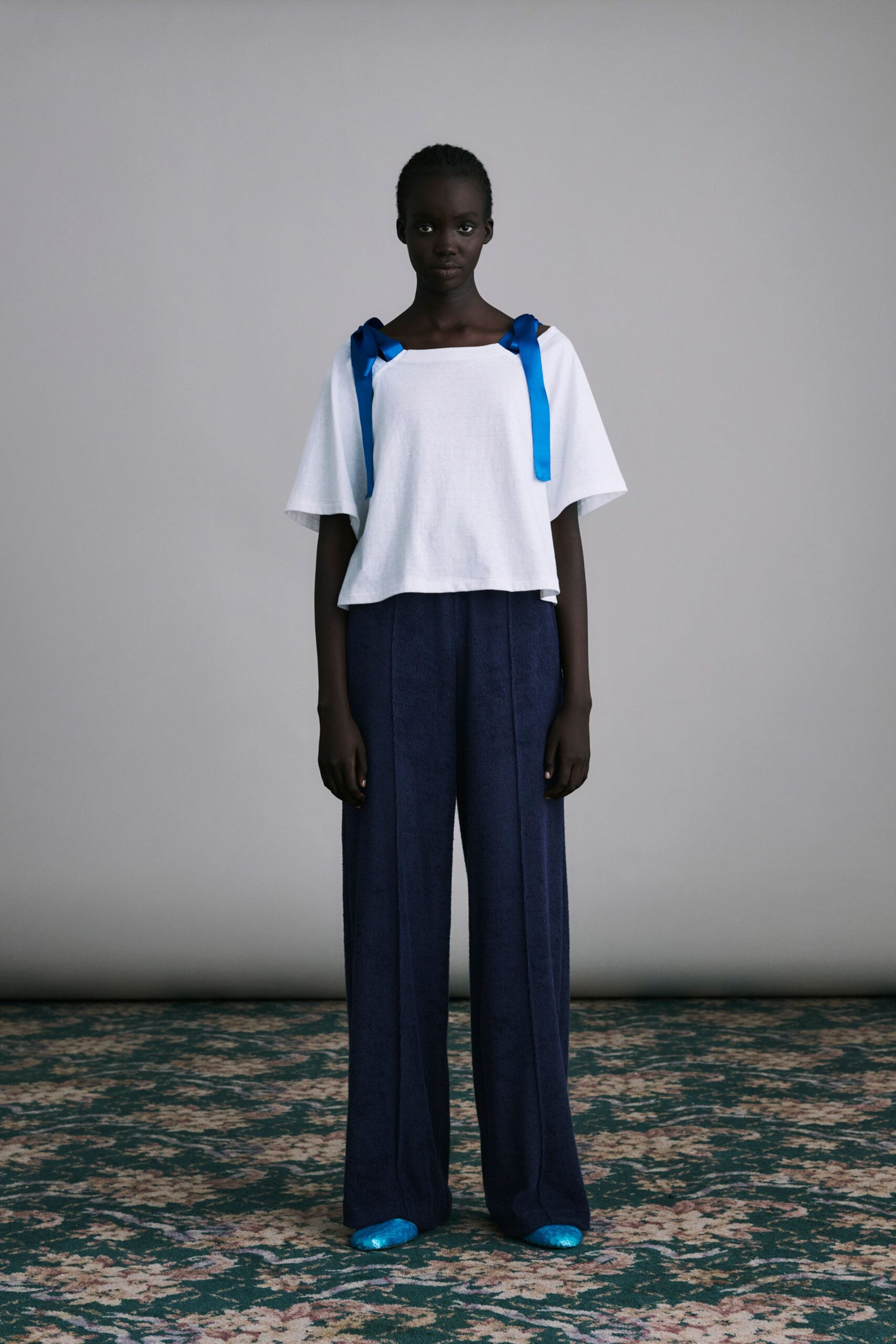 white relaxed top with blue pants