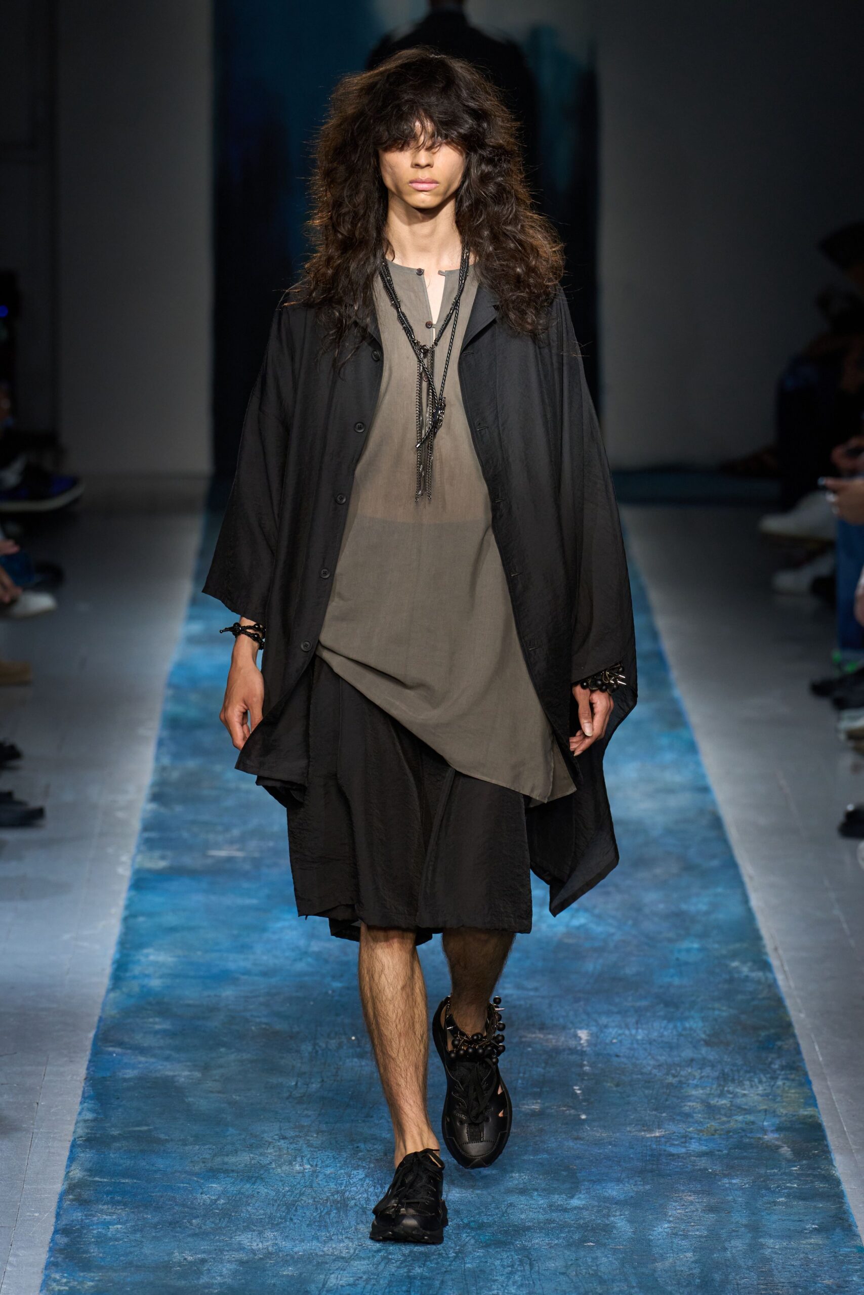 black coat gray top black shorts