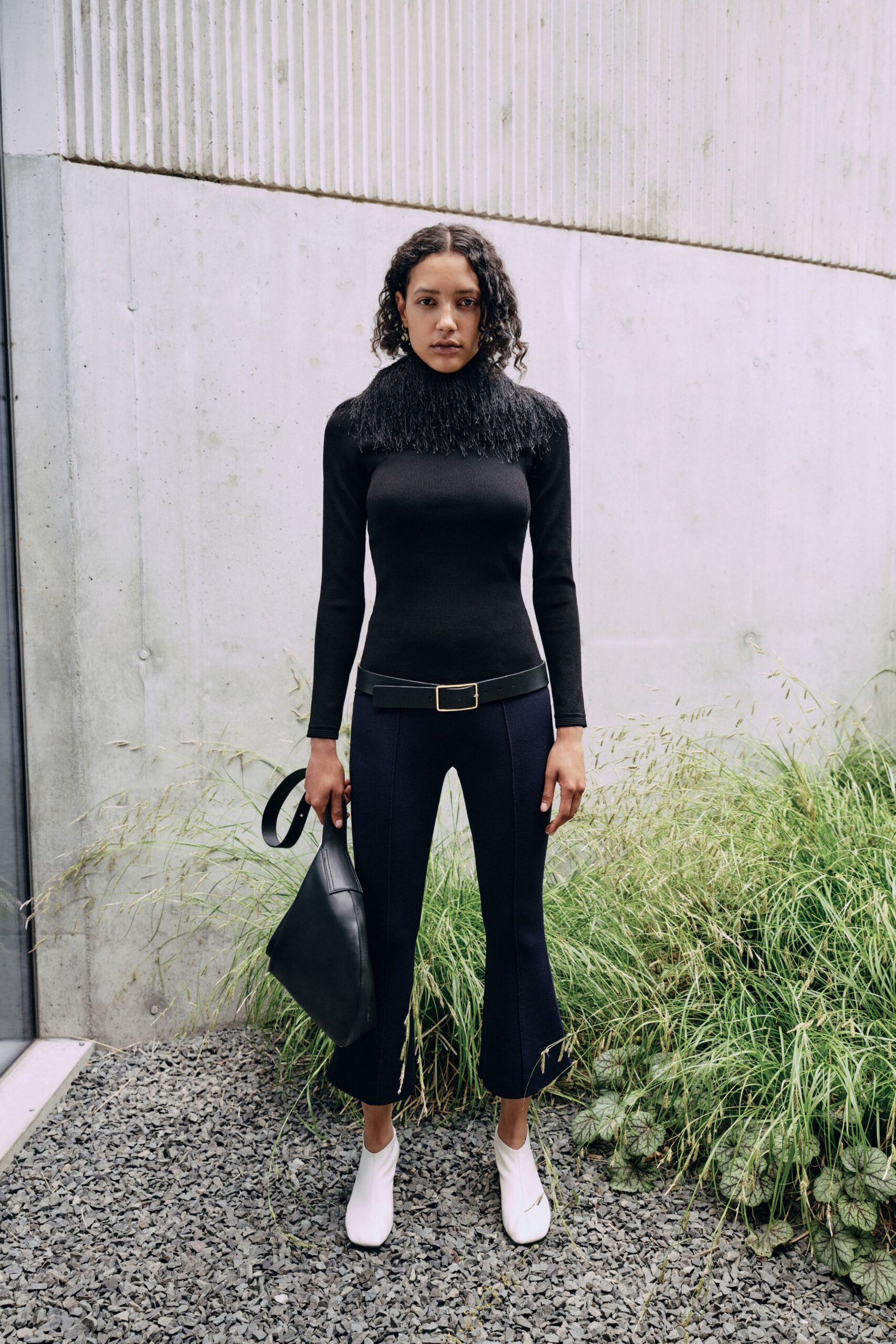 black fitted top with fringed detail