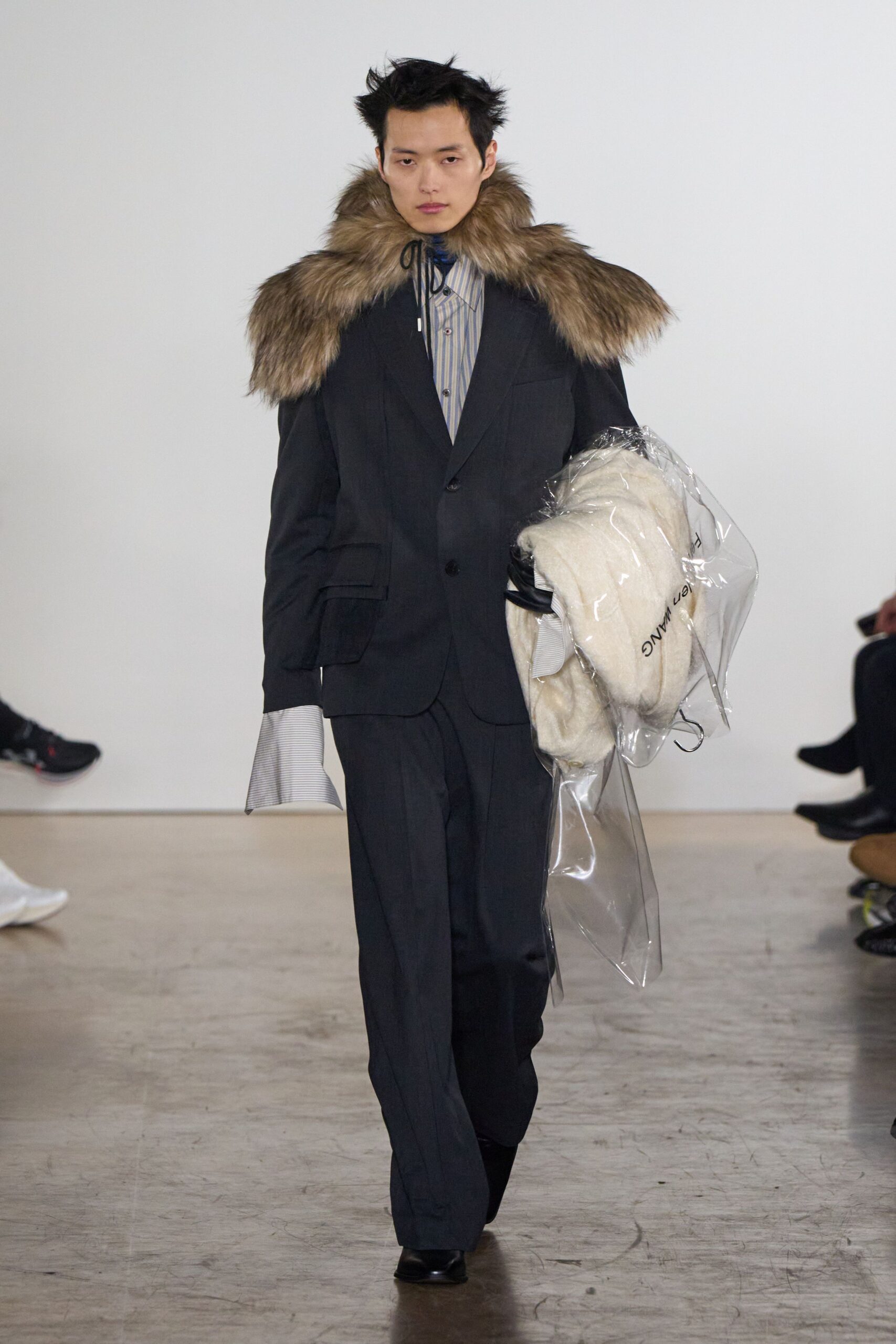 black tailored suit with fur cape
