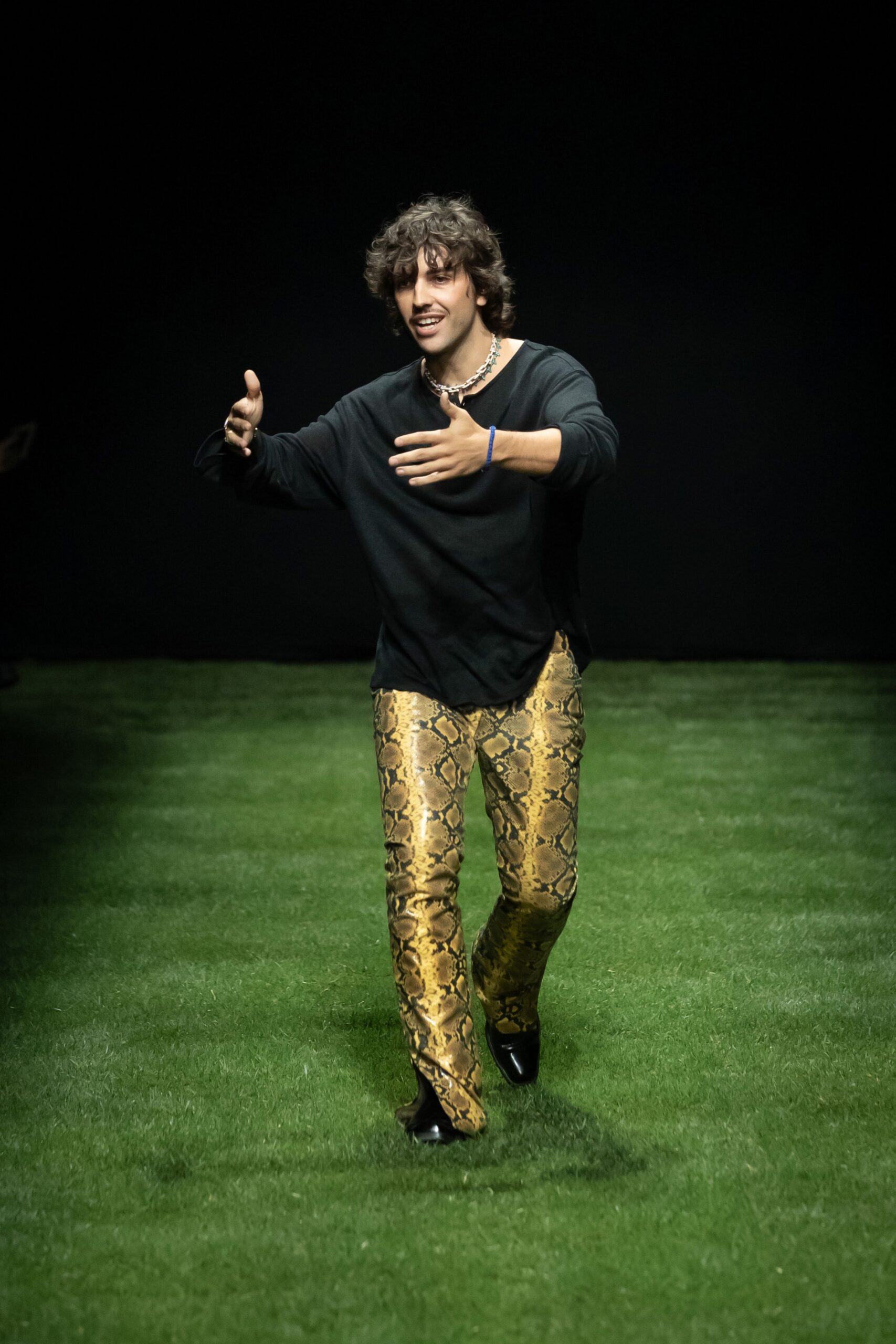 black relaxed top with gold printed pants