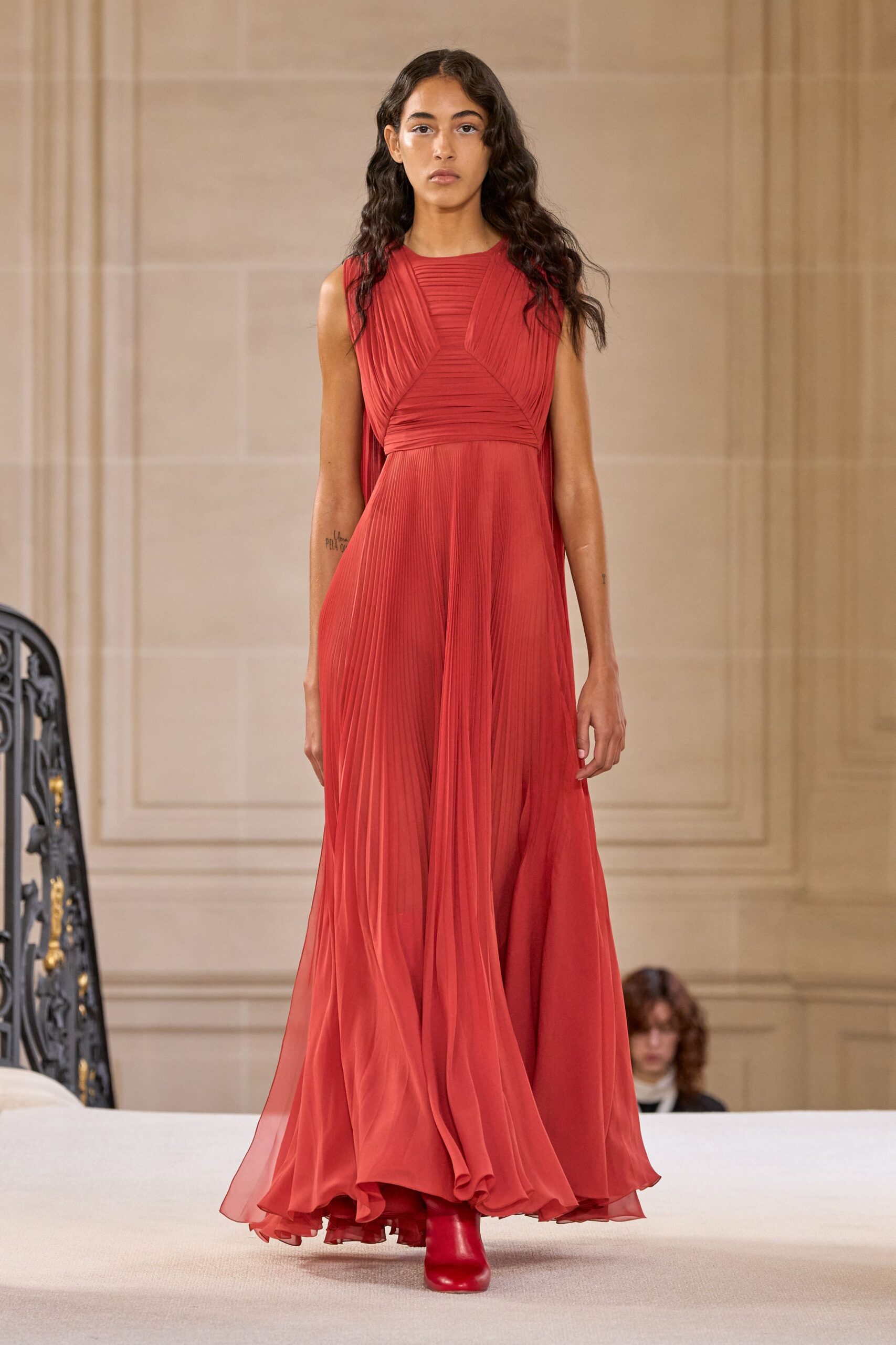 red chiffon sleeveless high-neck fitted pleated flowing gown