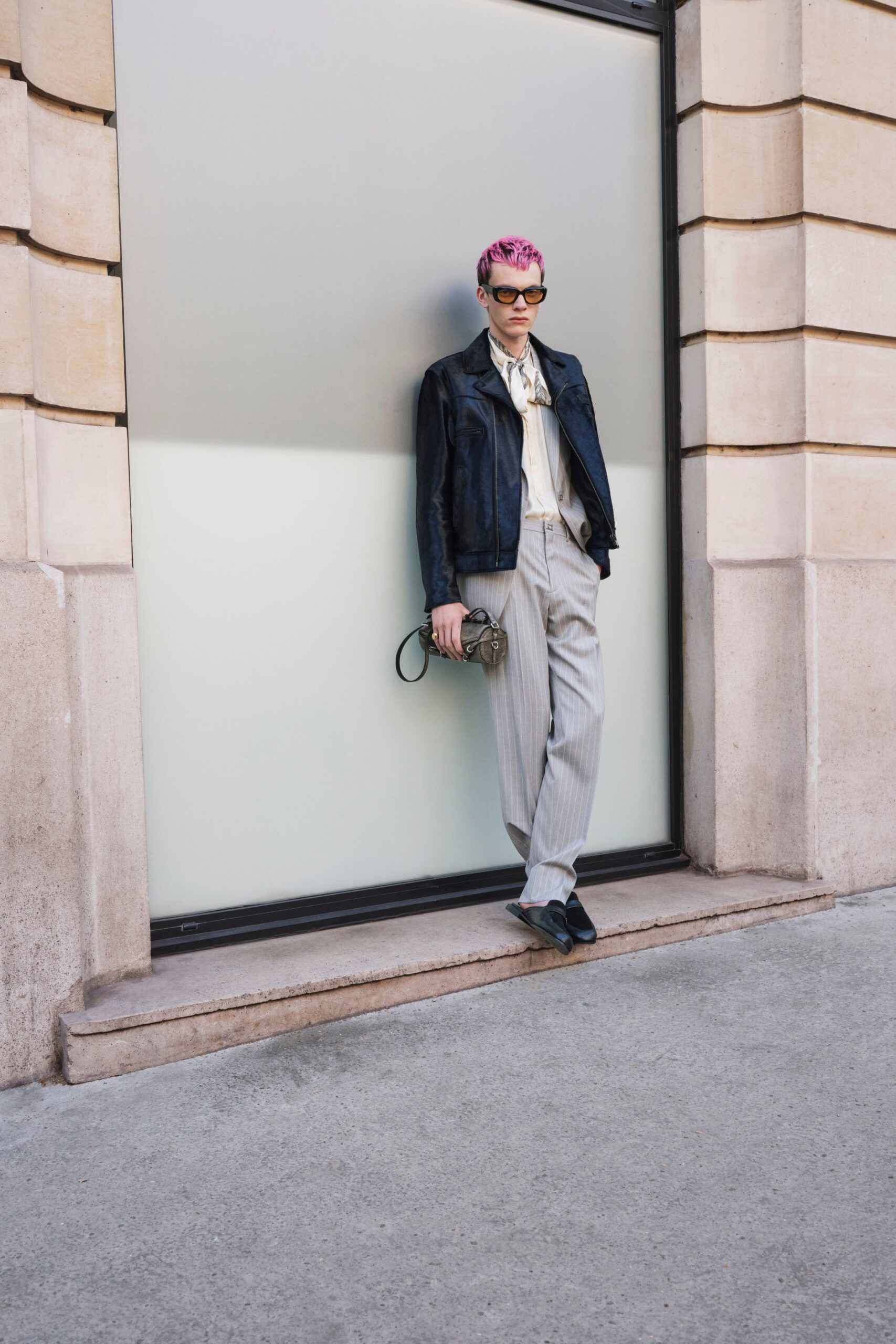 black leather jacket with gray pants