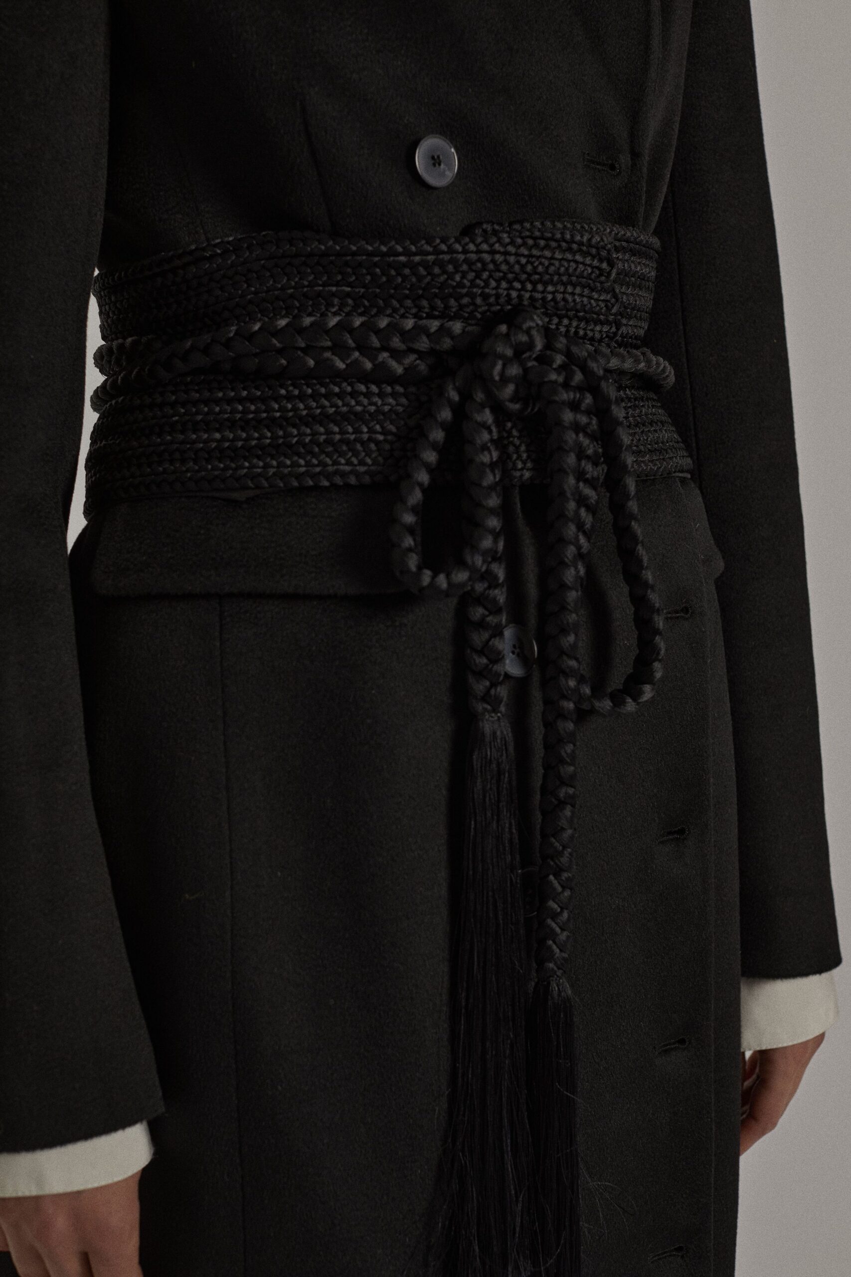 black fitted wool coat with braided belt