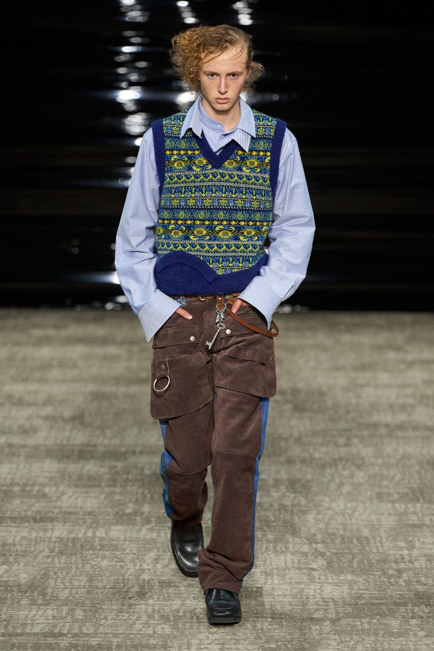 blue shirt green vest brown pants