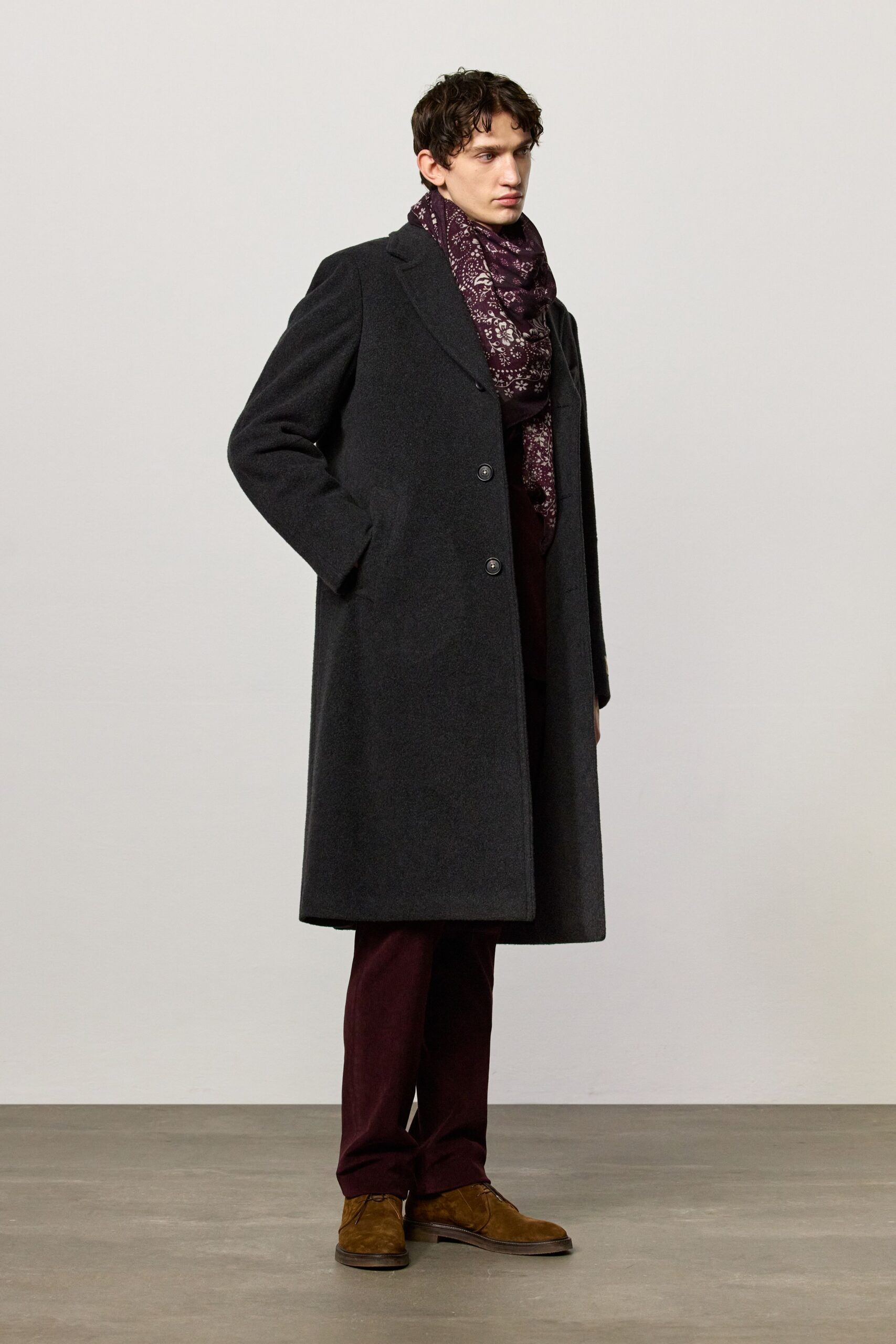 black wool coat with maroon pants