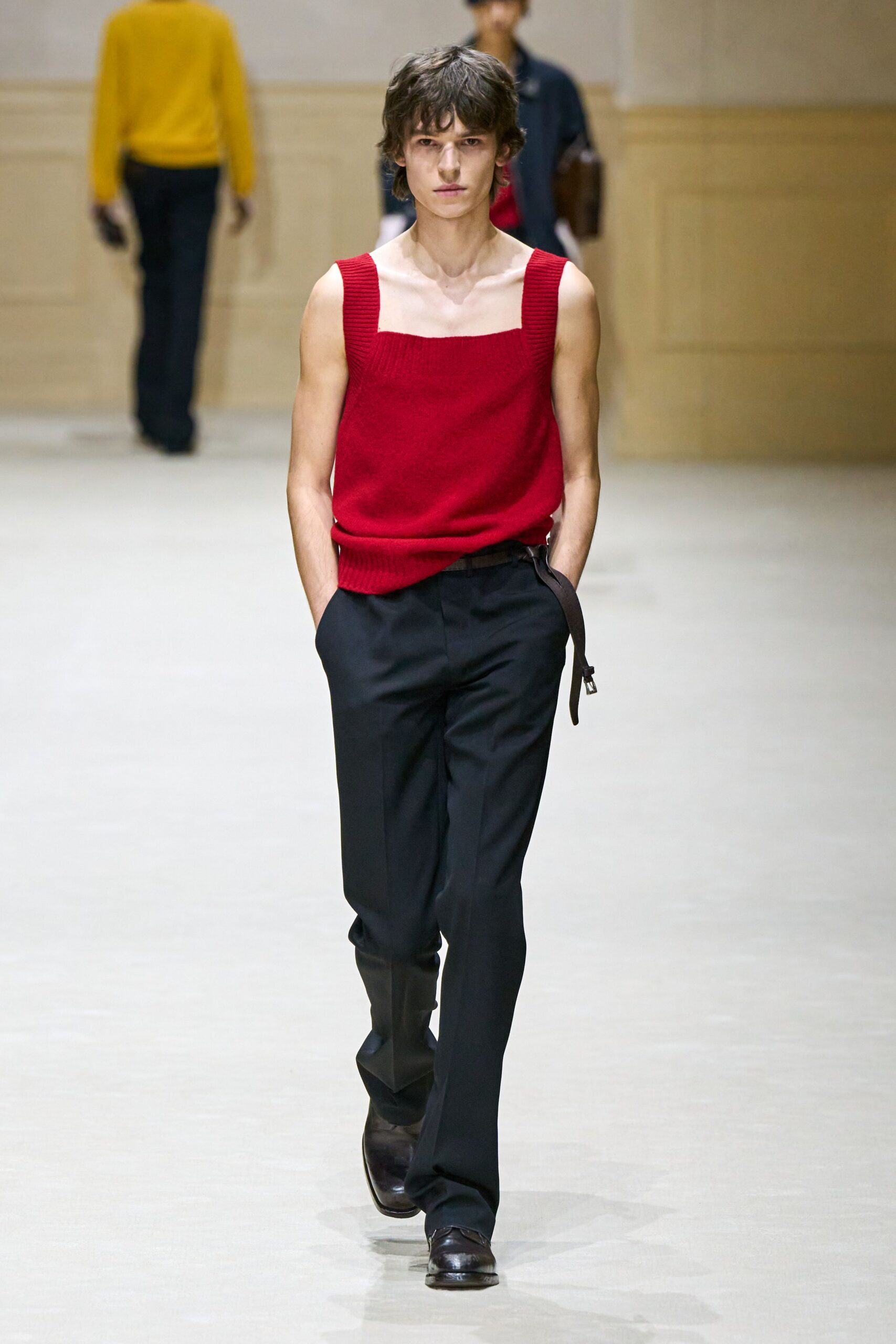 red fitted top with black pants