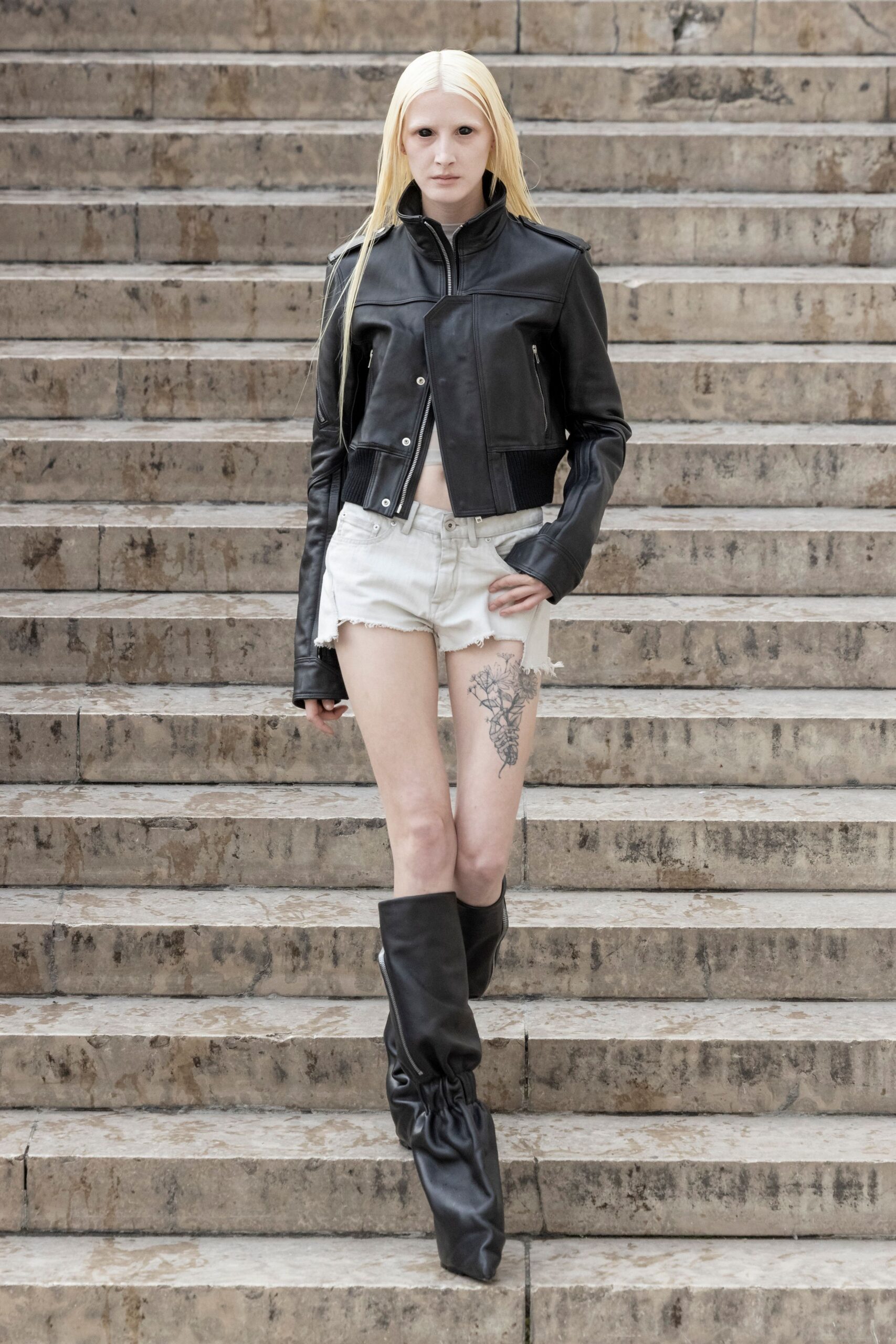 black leather jacket with white shorts