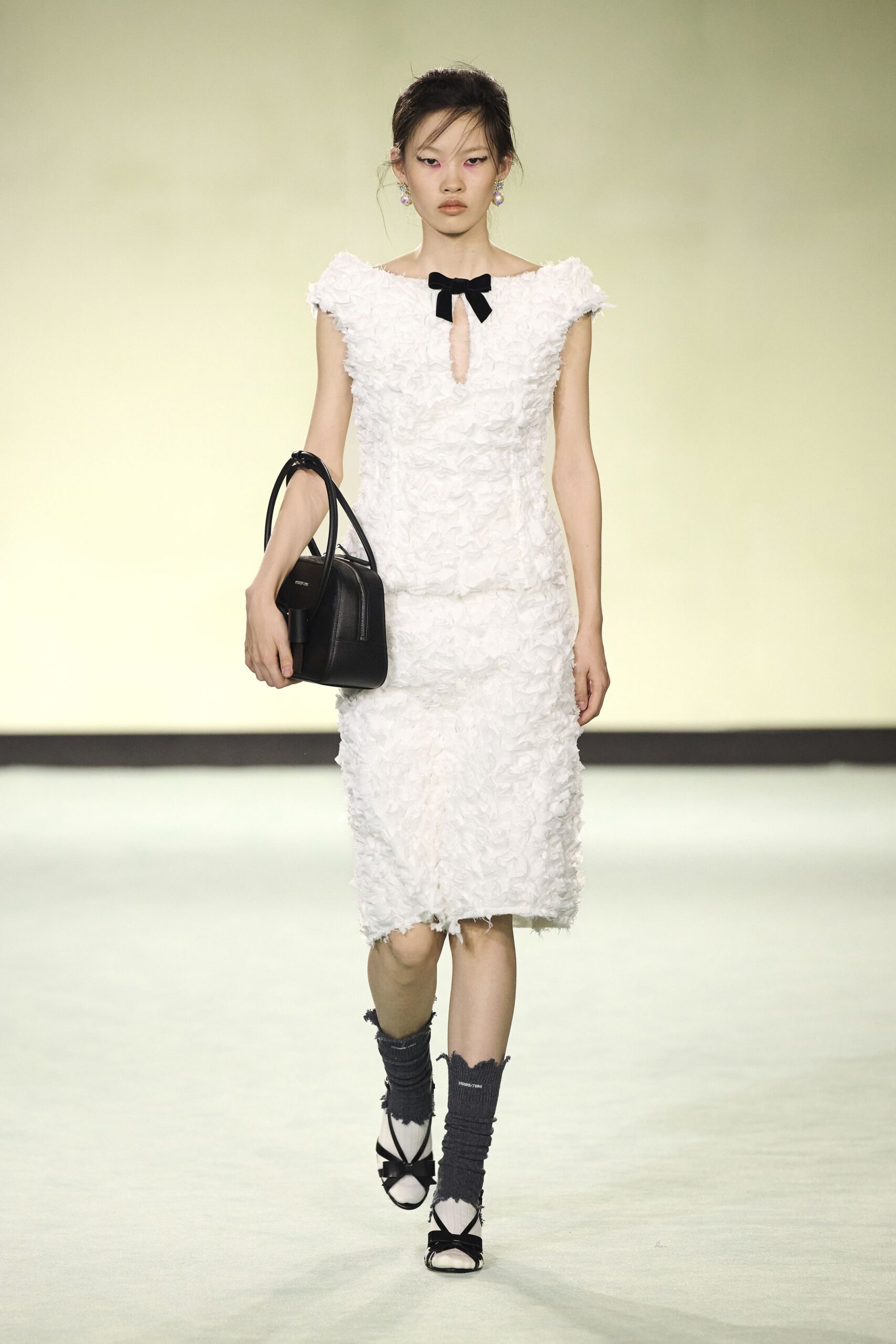 white ruffled midi dress with black accessories