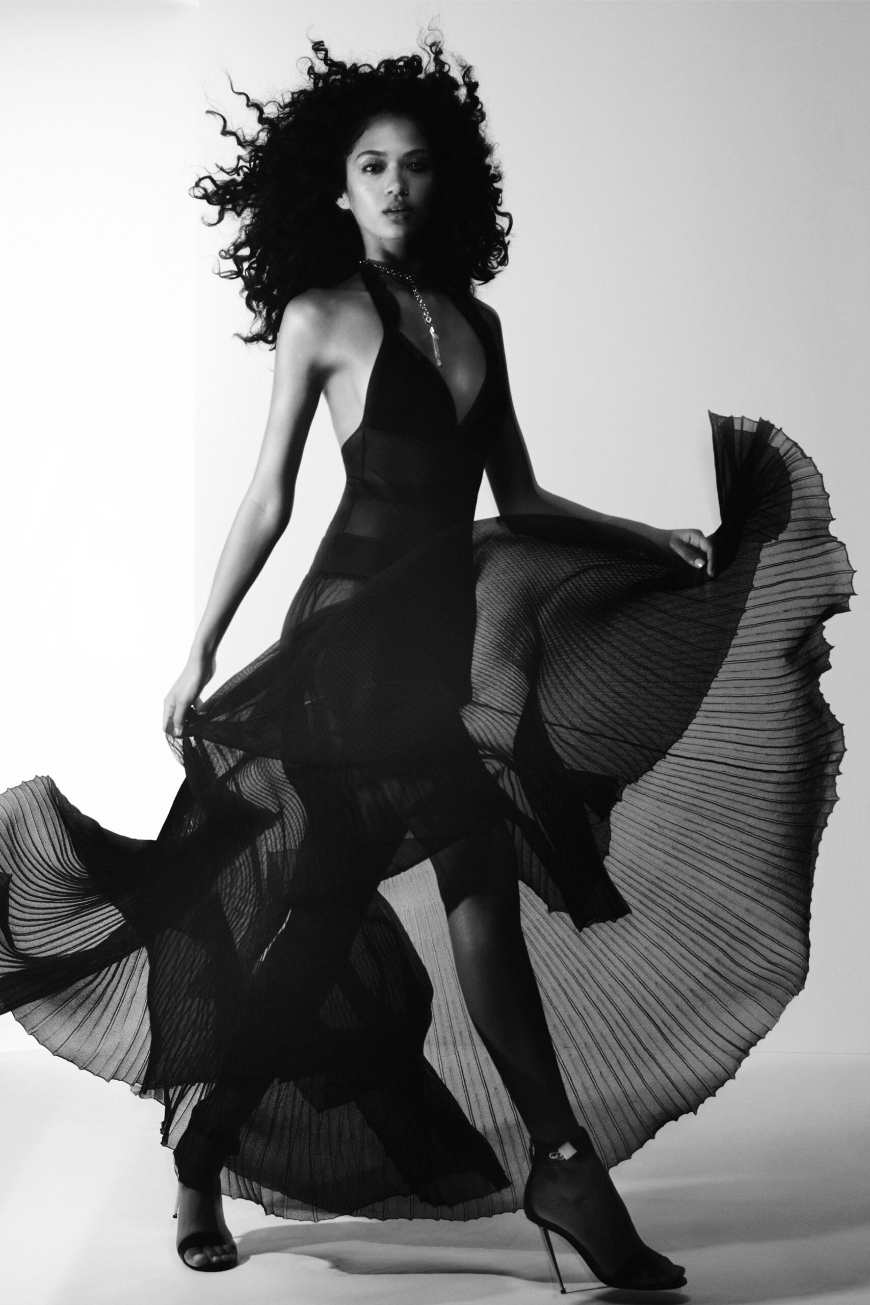 black silk sleeveless v-neck fitted pleated flowing gown