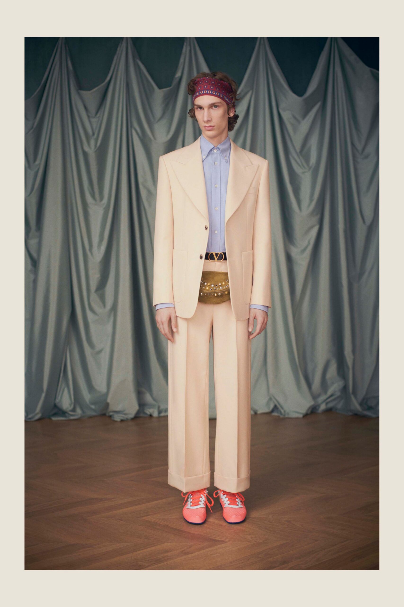 beige tailored suit with blue shirt