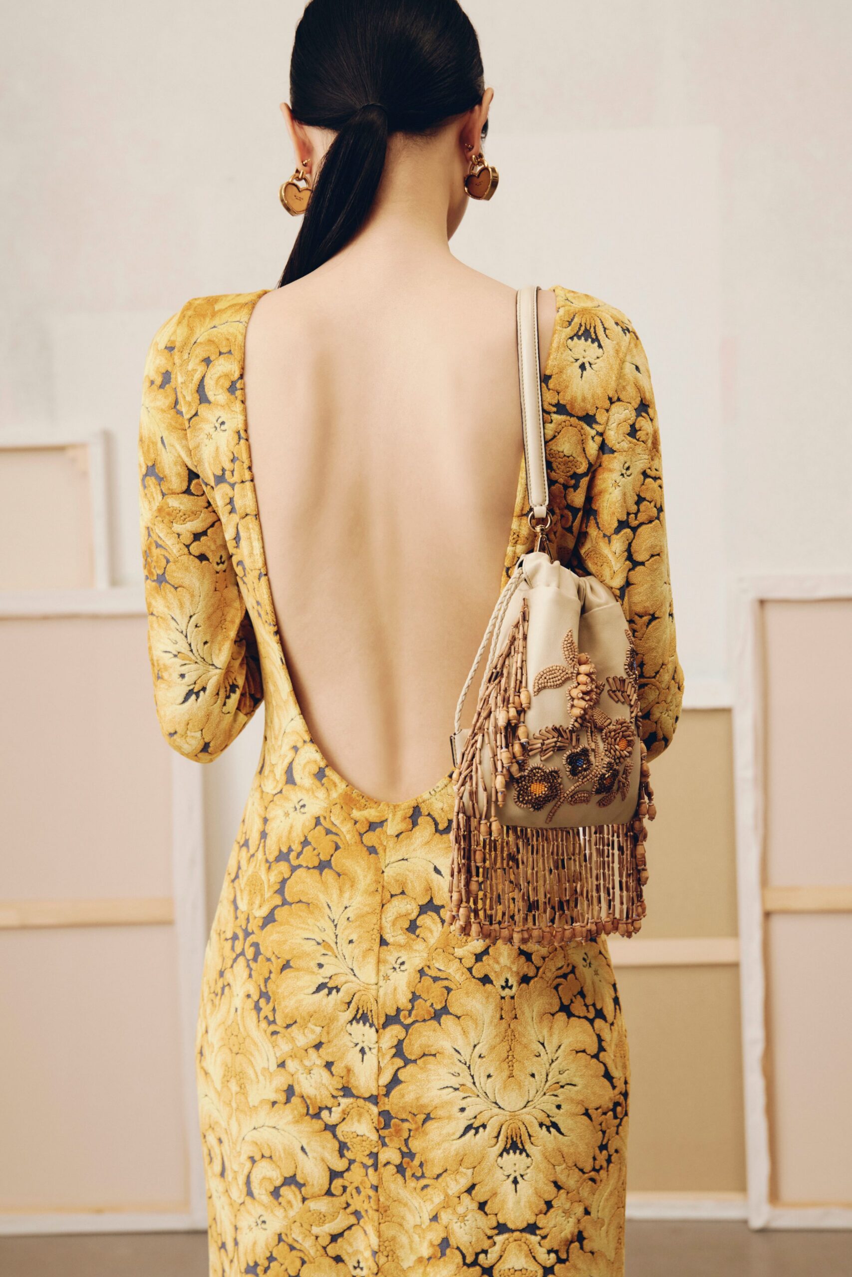 yellow embroidered backless gown with bag