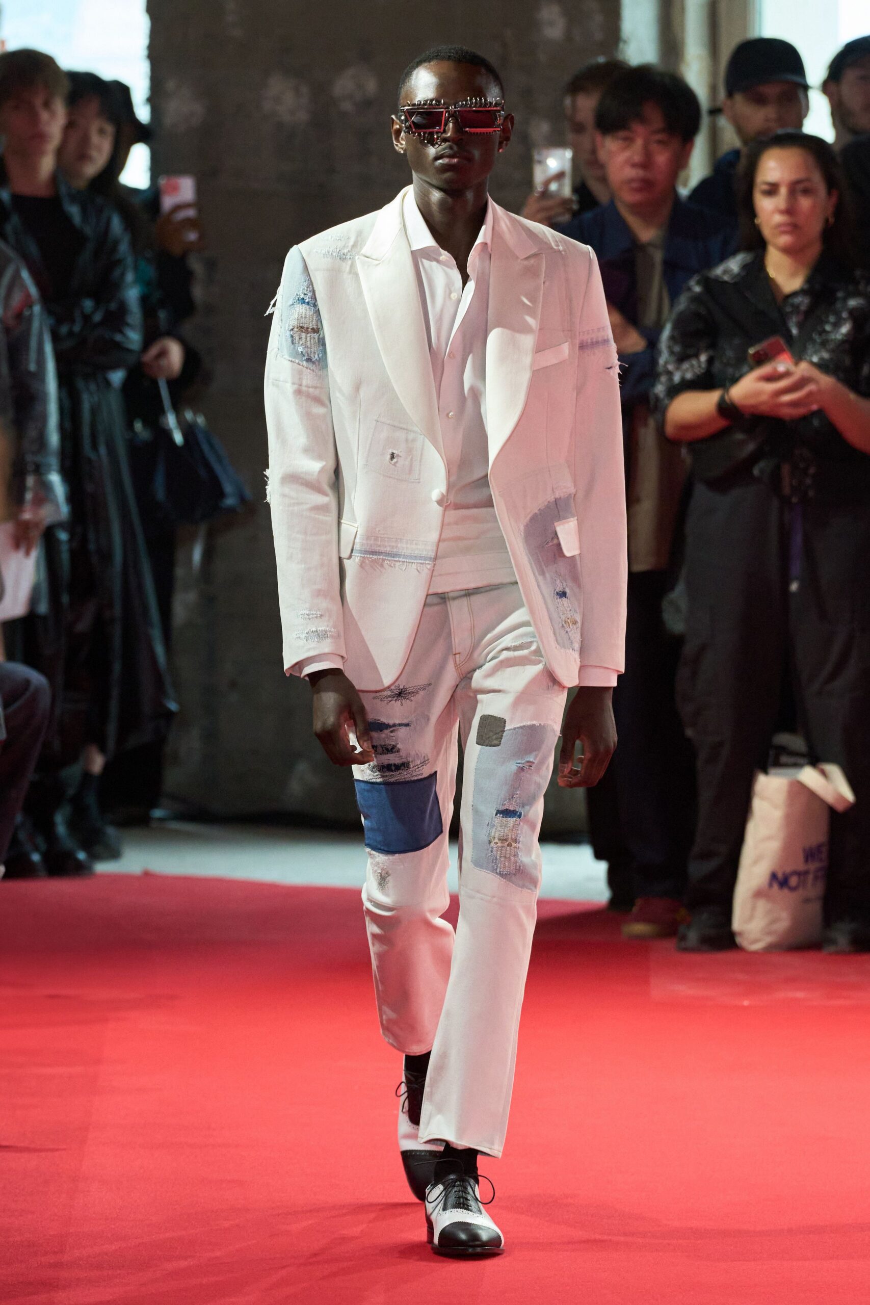 white tailored suit with red sunglasses